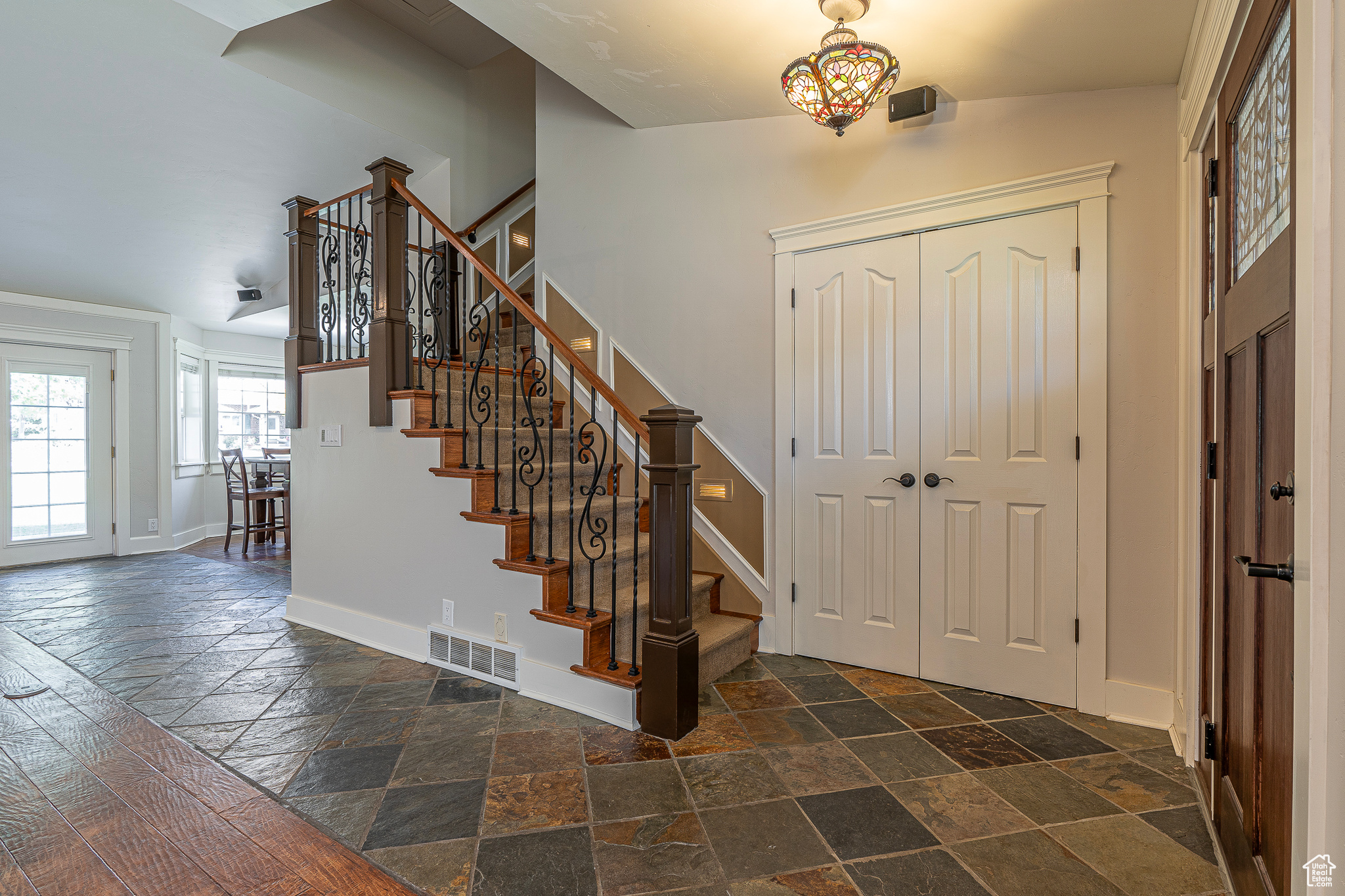 Entrance foyer with vaulted ceiling and dark hardwood / wood-style flooring