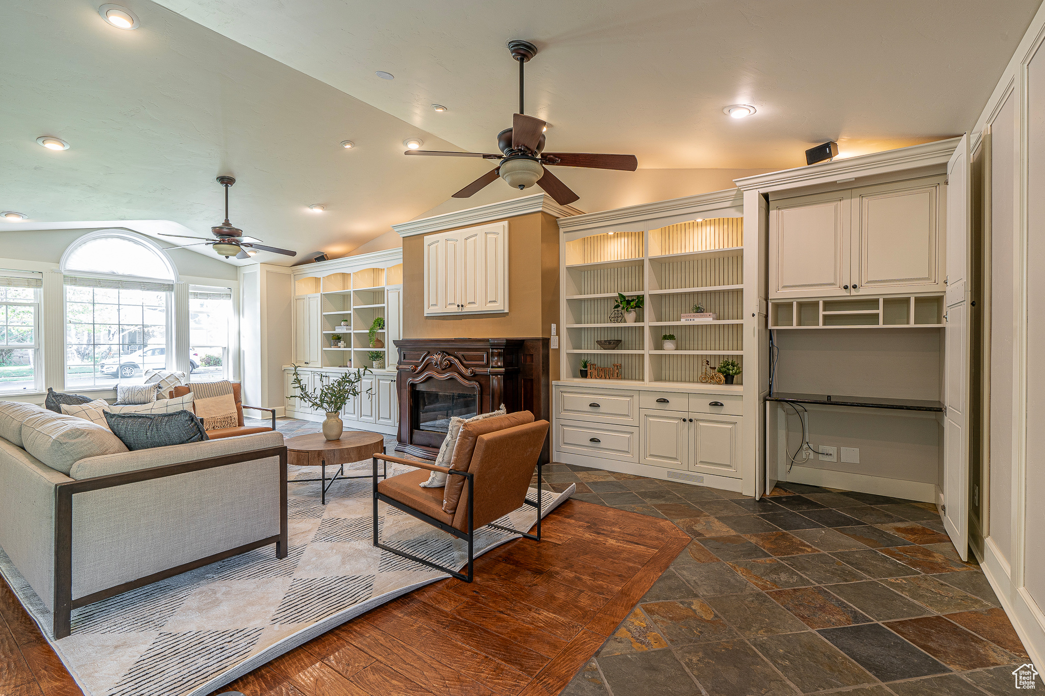 Living room with lofted ceiling and ceiling fan