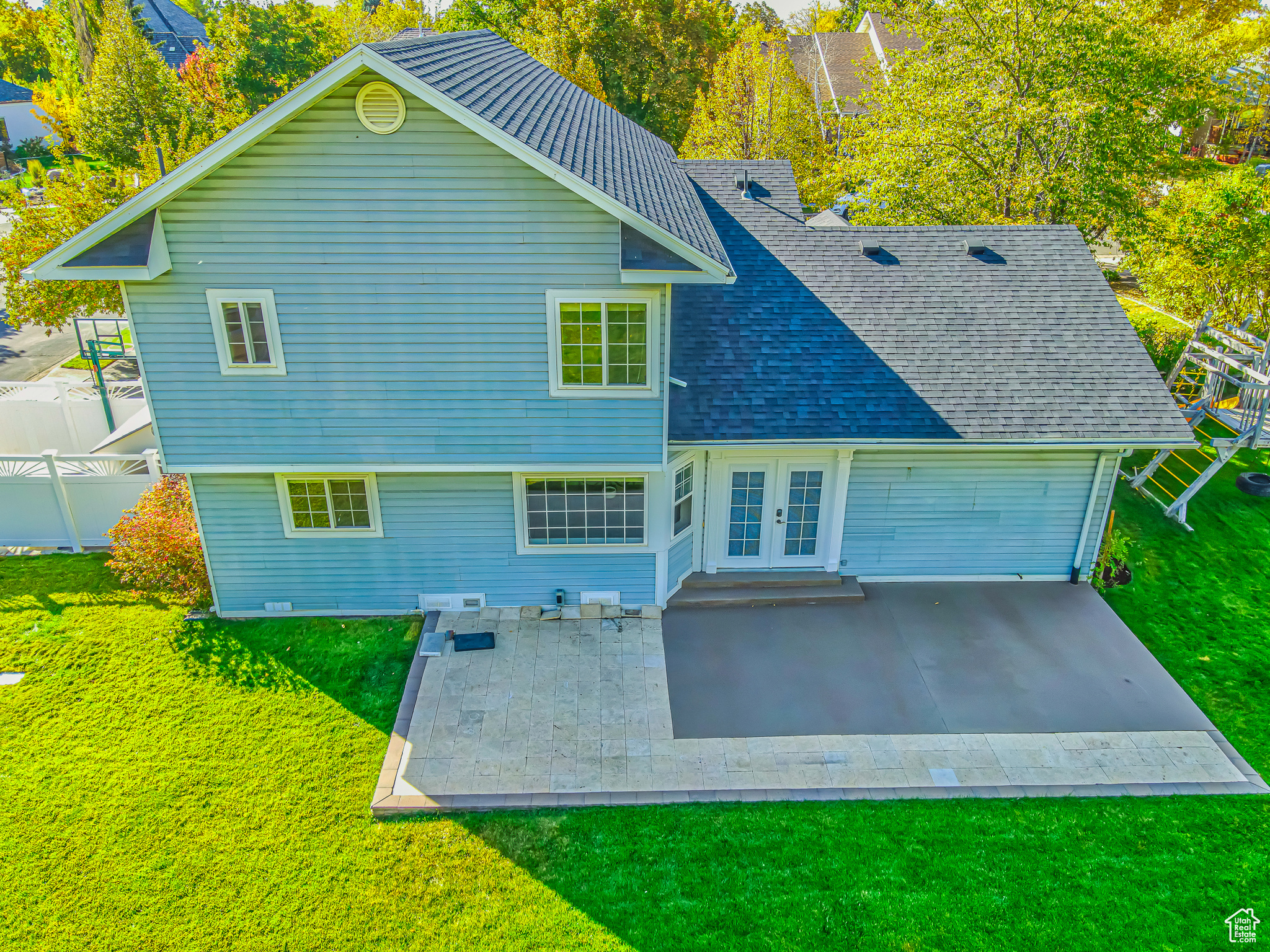 Rear view of property with a patio area and a lawn