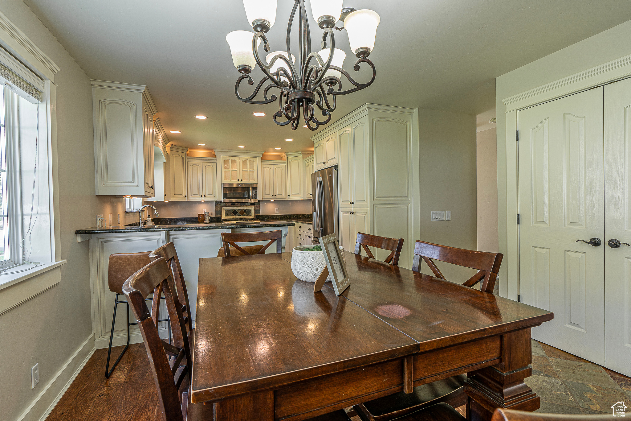 Dining room with an inviting chandelier, dark hardwood / wood-style floors, and sink