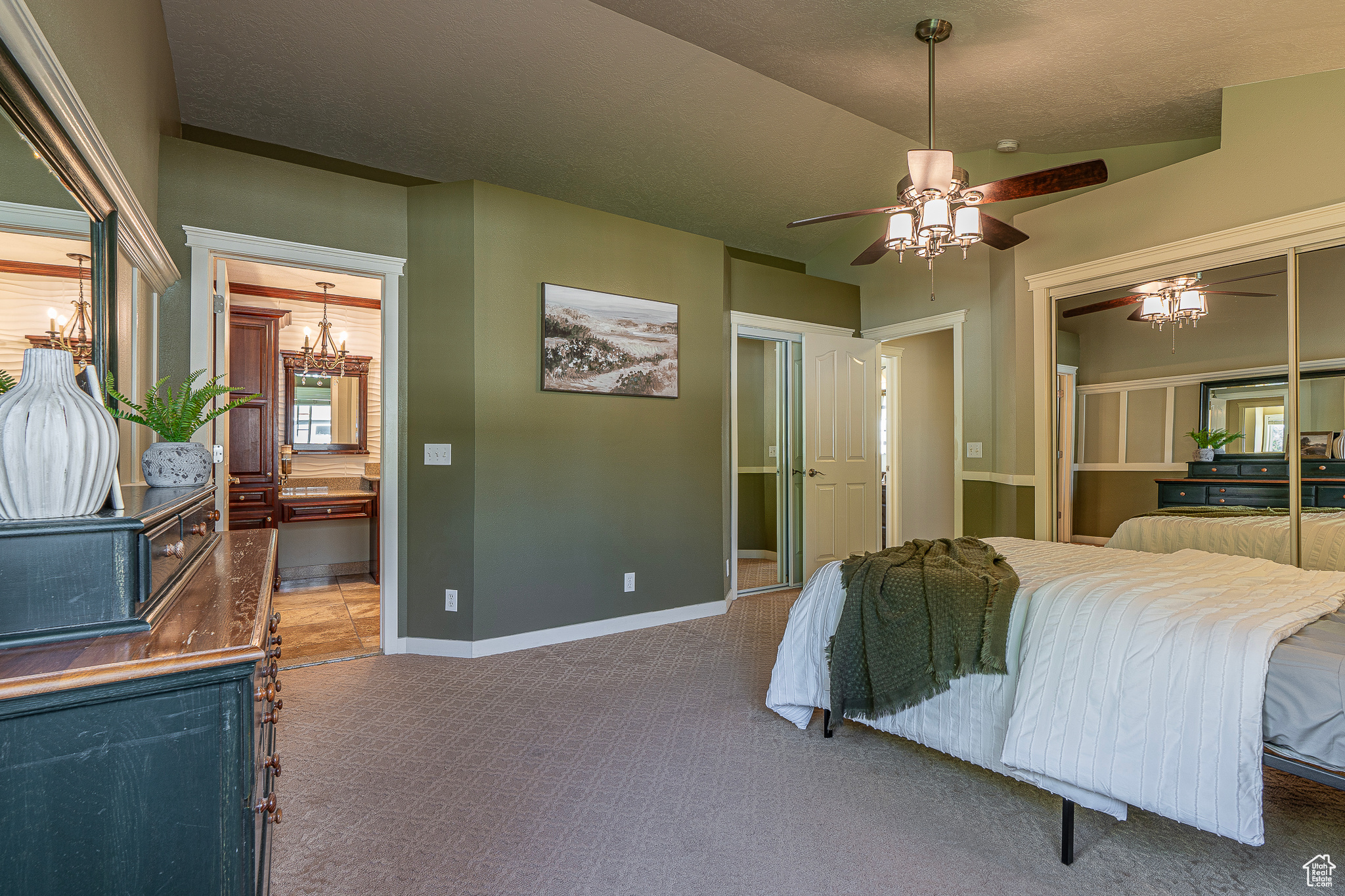 Carpeted bedroom featuring a textured ceiling and ceiling fan