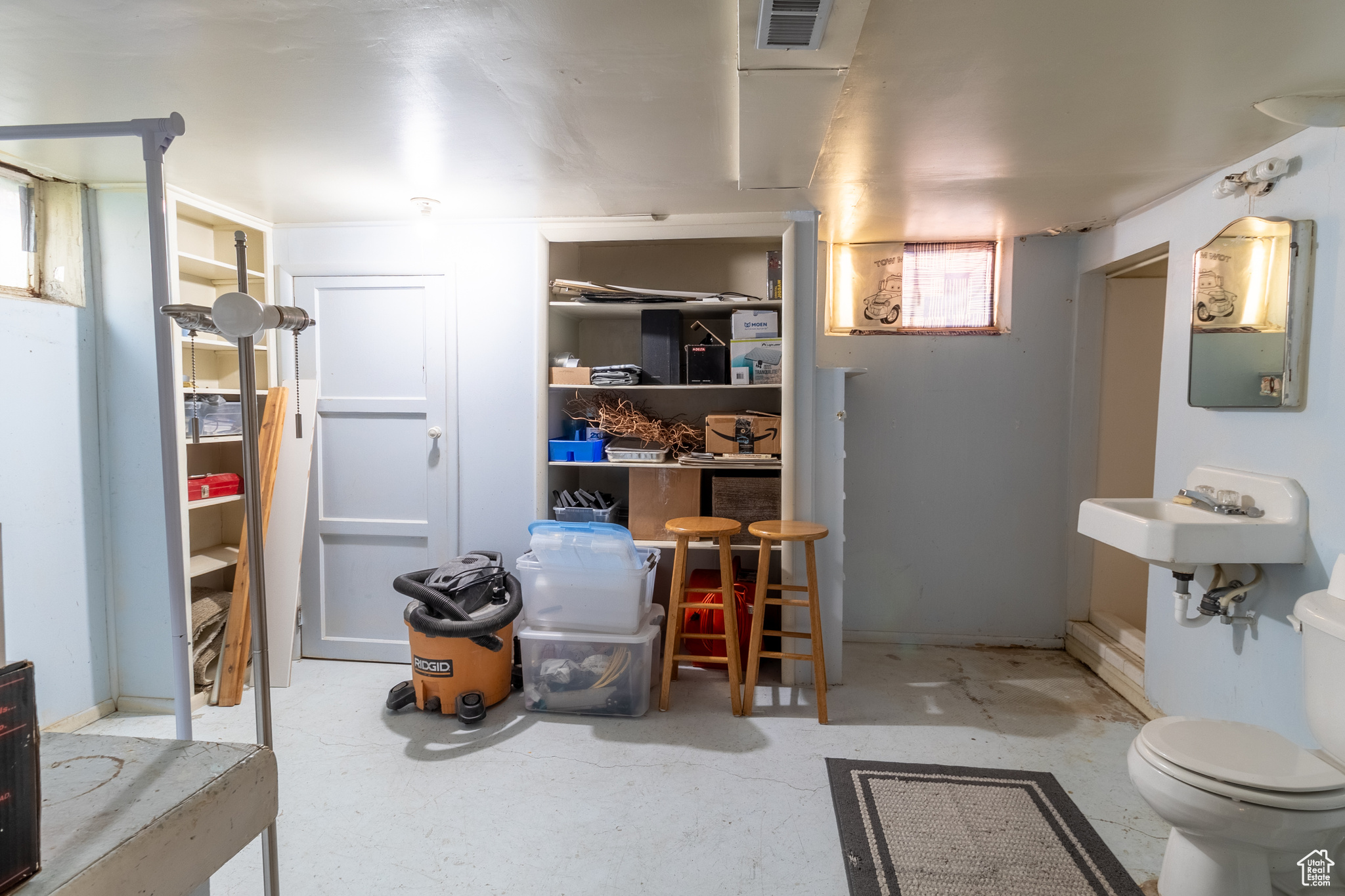 Interior space with toilet and concrete floors