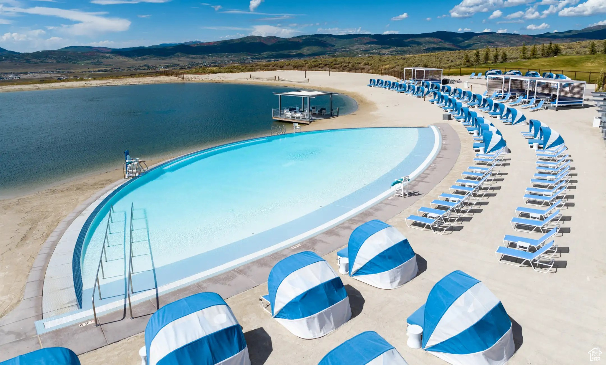 View of pool with a water and mountain view