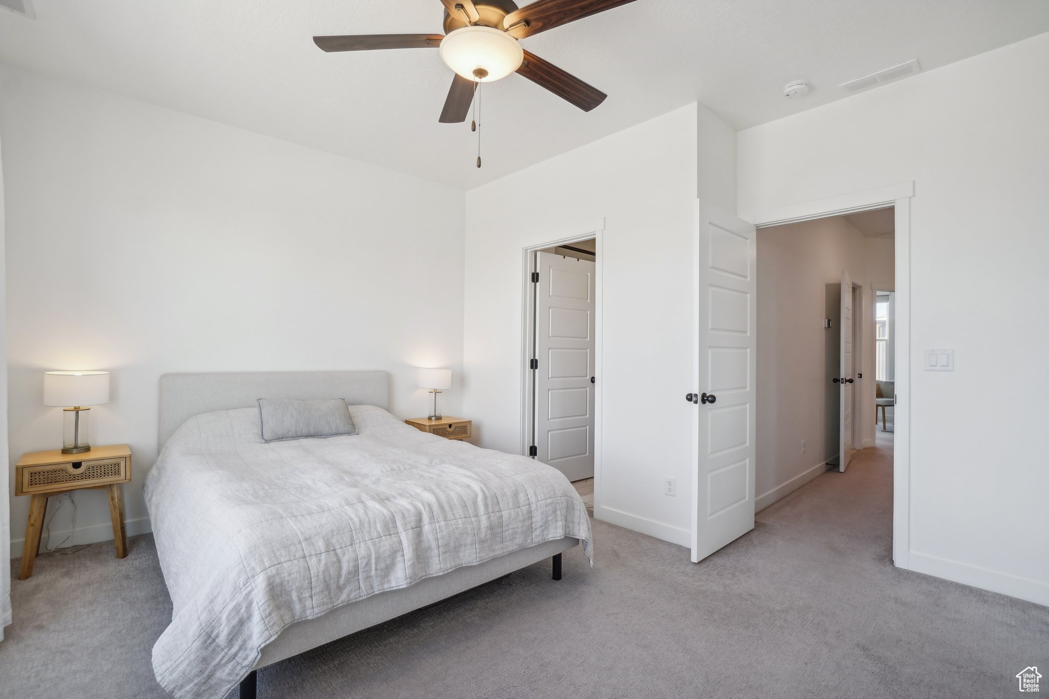 Bedroom featuring ceiling fan and light carpet