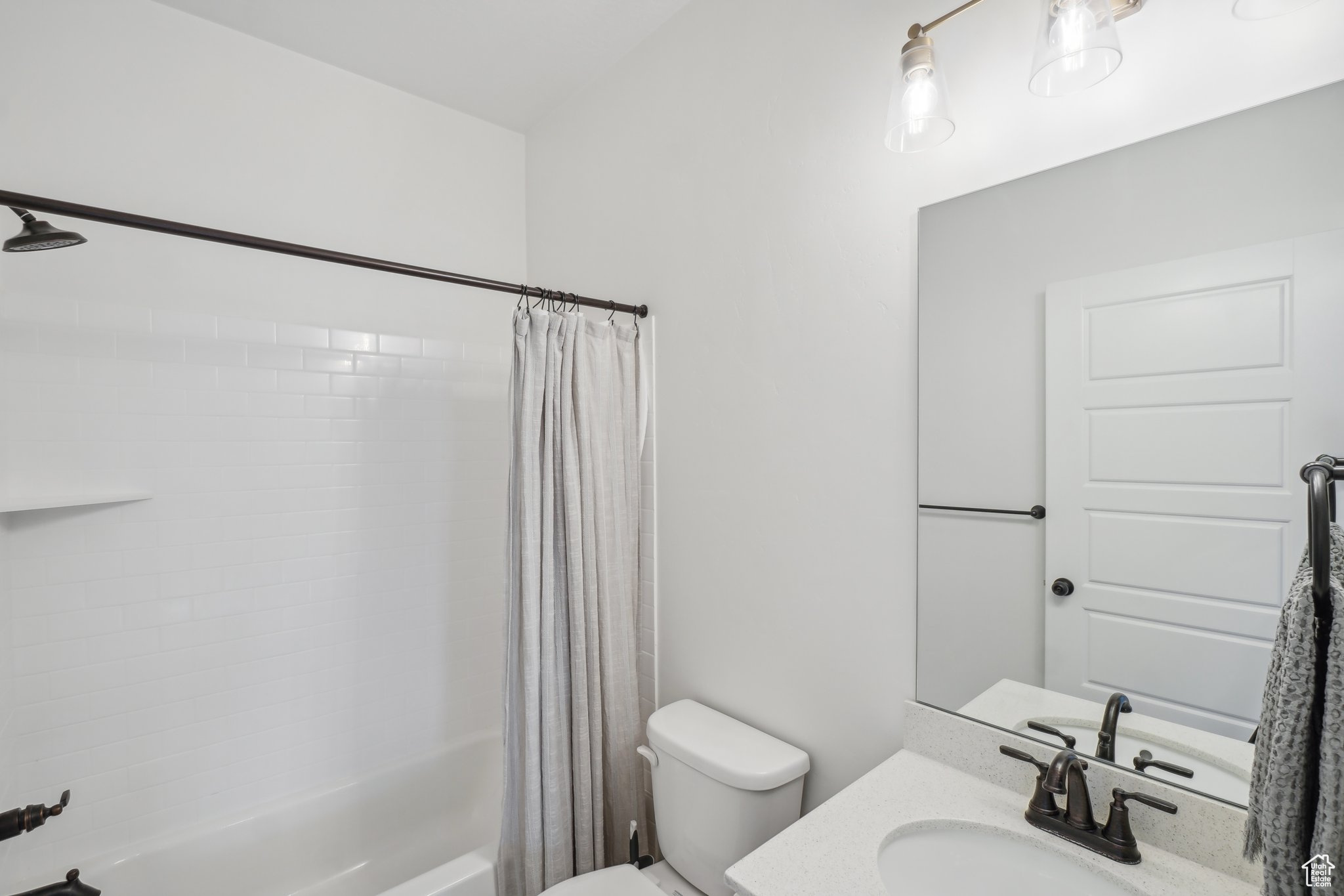 Full bathroom with vanity, toilet, and shower / bathtub combination with curtain