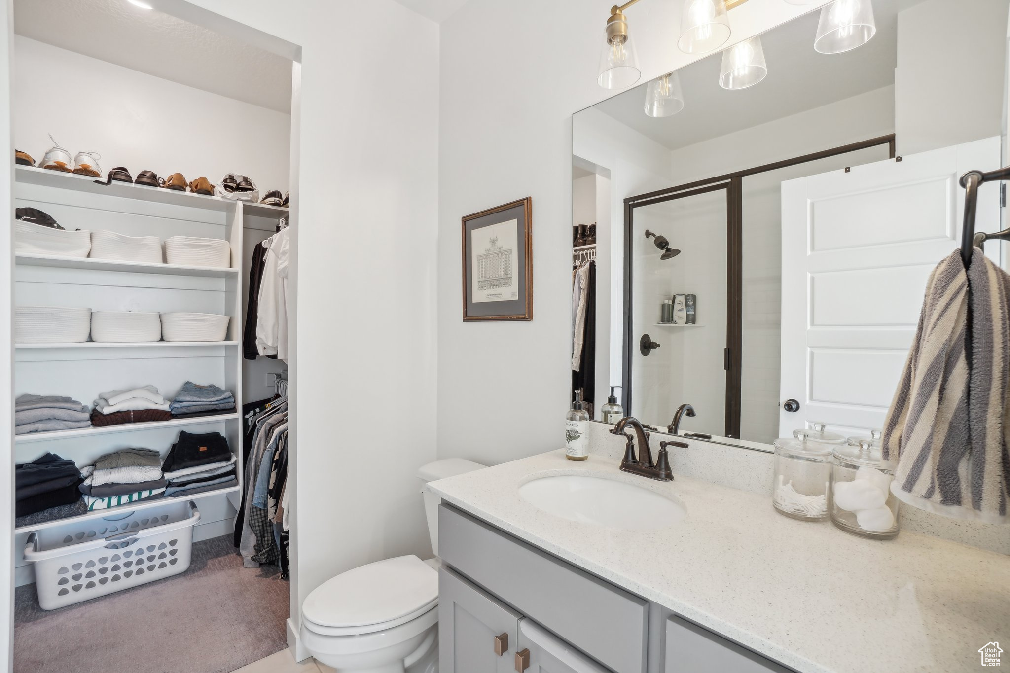 Bathroom with vanity, walk in shower, and toilet