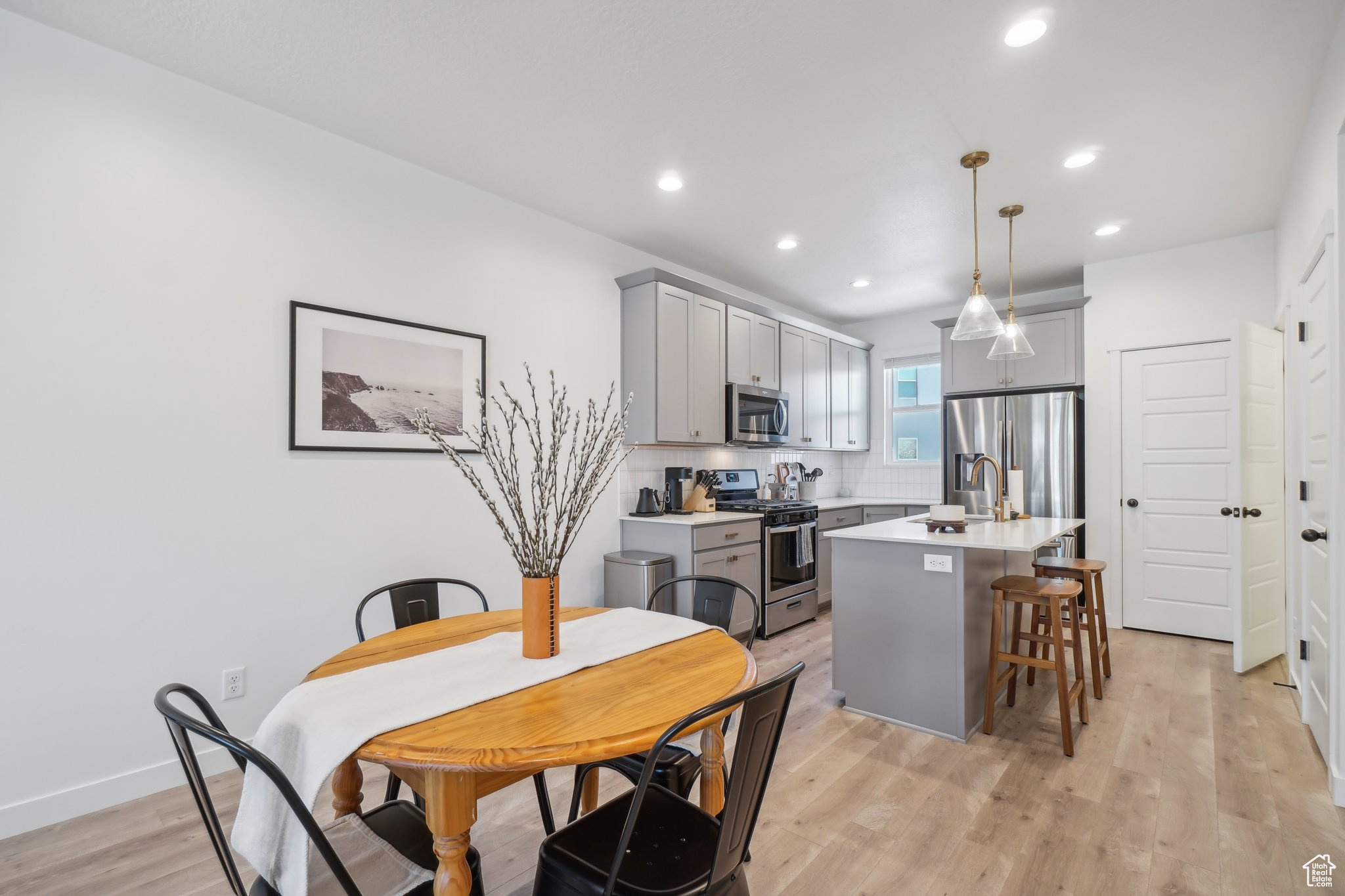 Dining area featuring sink and light hardwood / wood-style flooring