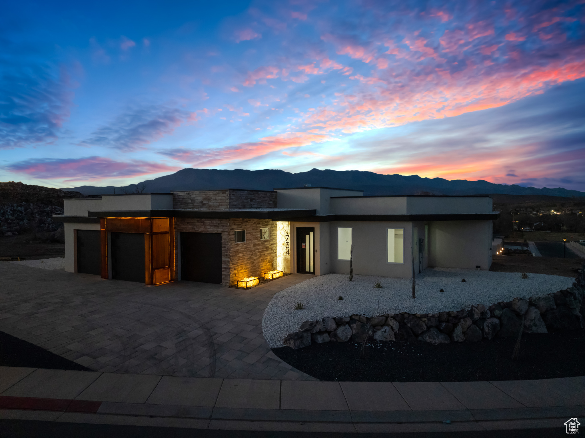 View of front of home with a garage and a mountain view