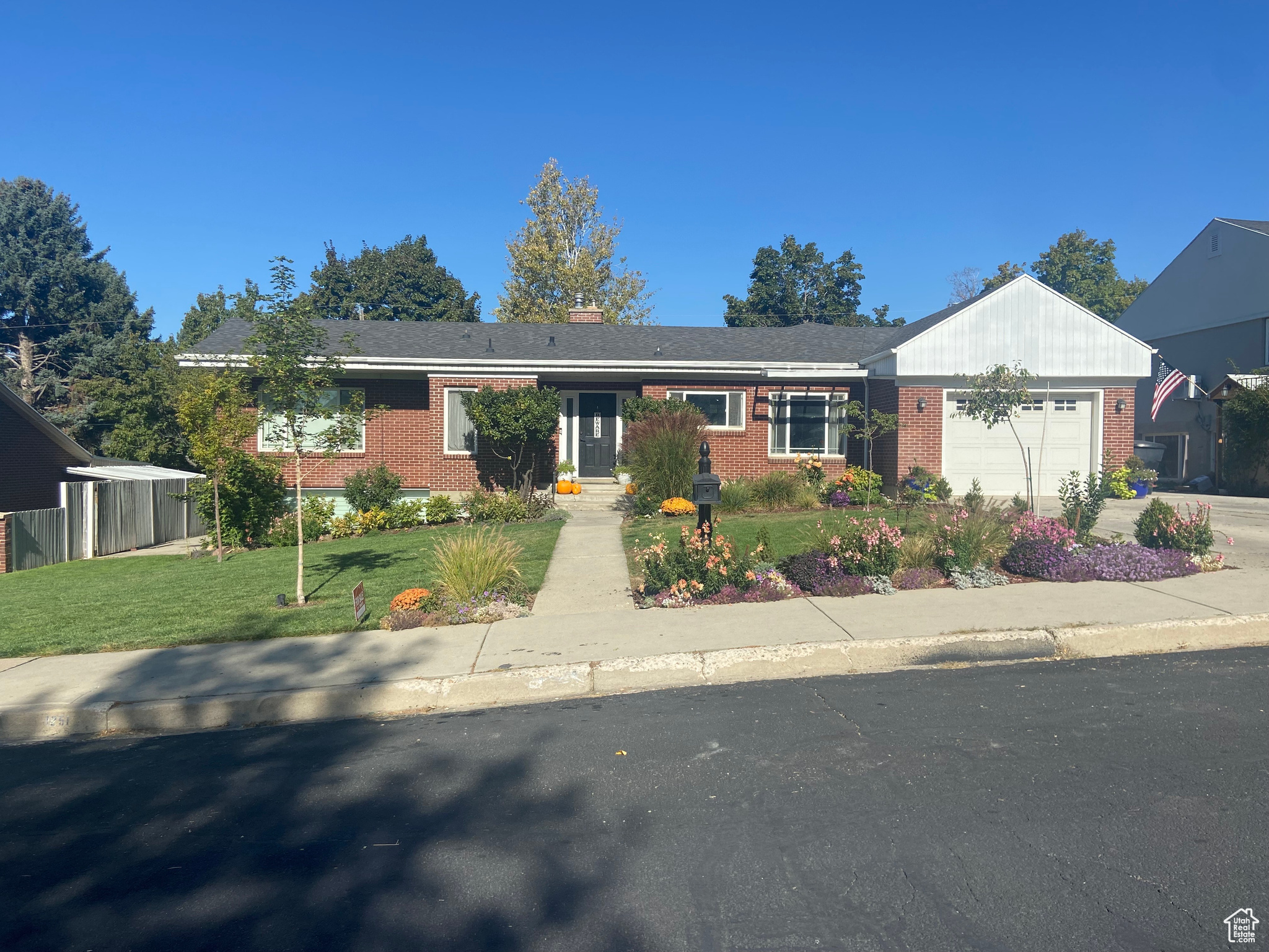 View of front of house with a front yard and a garage