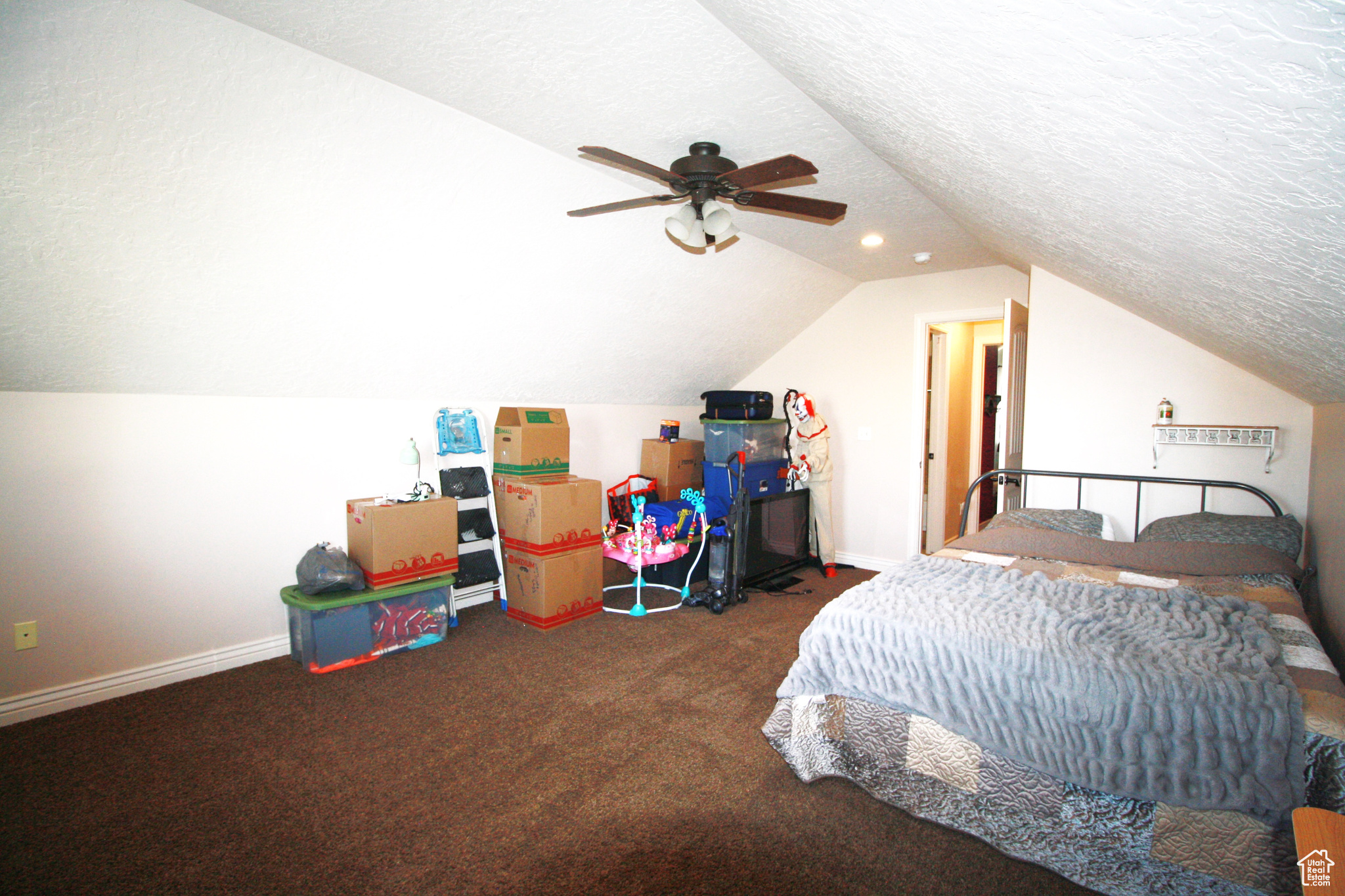 Carpeted bedroom 5, with lofted ceiling, a textured ceiling, and ceiling fan