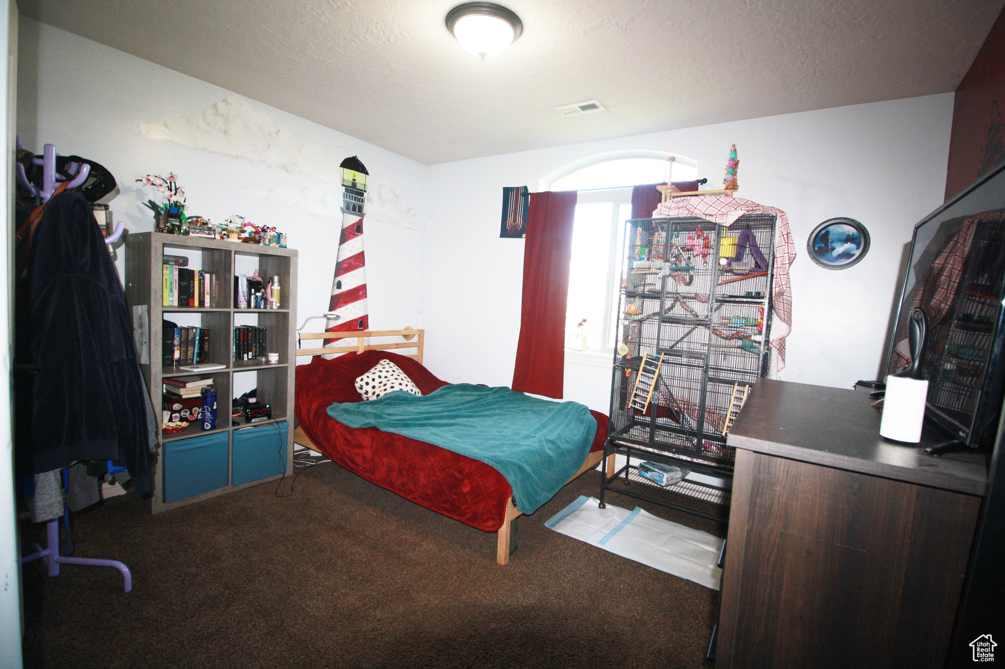 Bedroom 2 featuring a Lighthouse, with textured ceiling, carpet flooring.