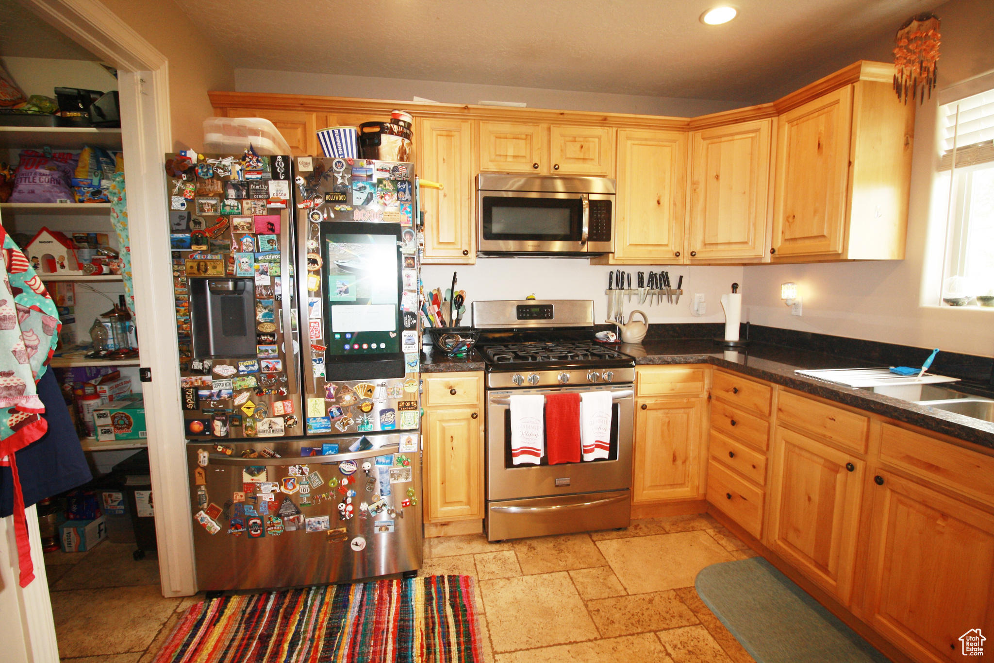 Kitchen with stainless steel appliances and light brown cabinetry