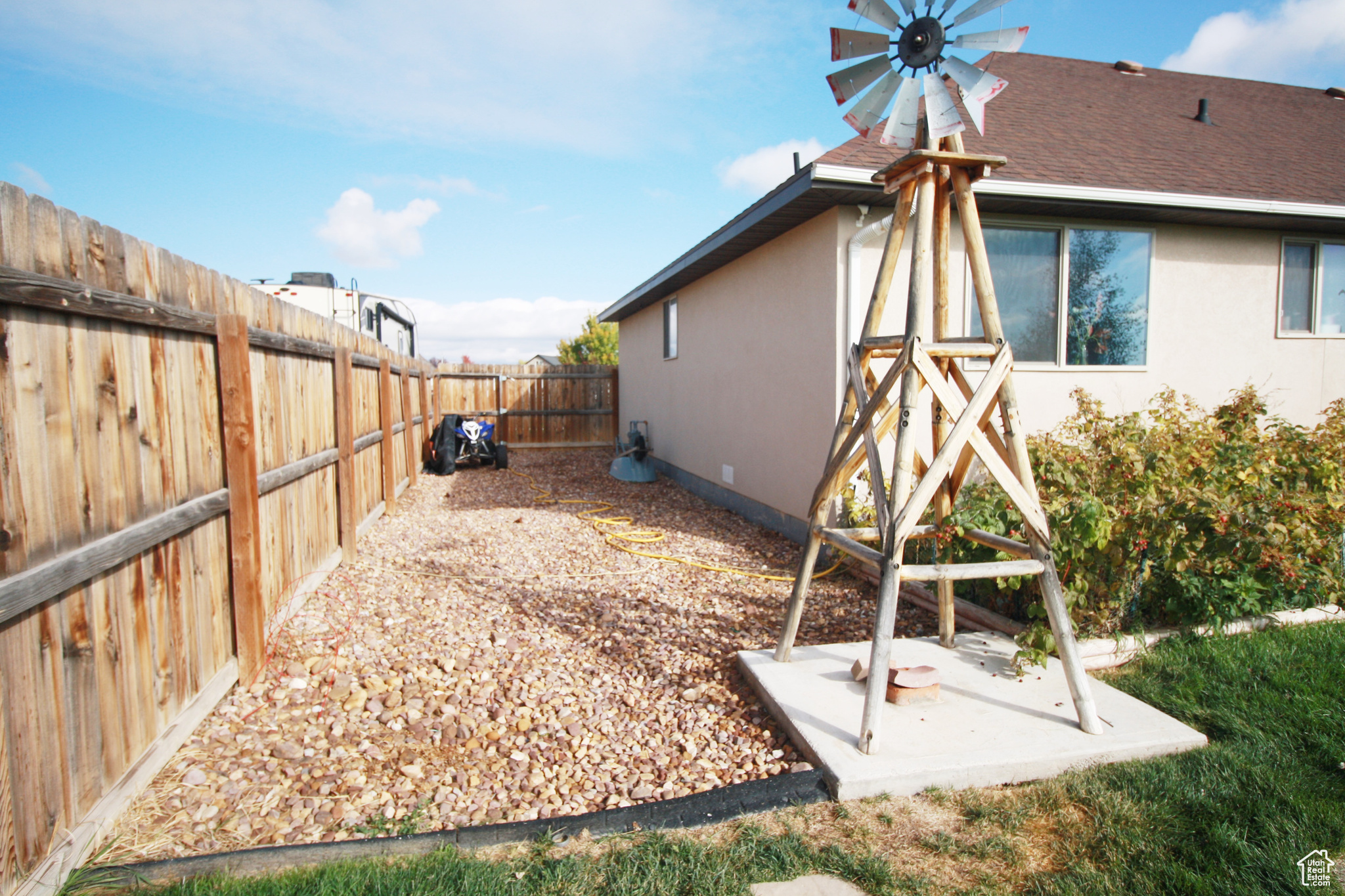 View of yard, RV Parking, Raspberries & Windmill.