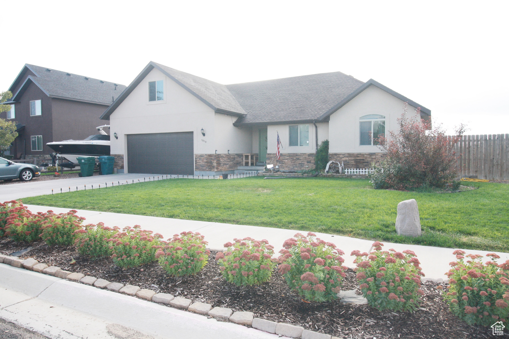 View of front of home with a front lawn, RV parking, and a garage