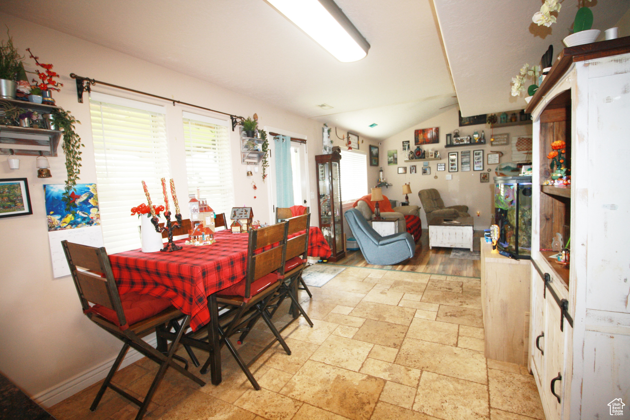 Dining room with light hardwood / wood-style flooring and lofted ceiling