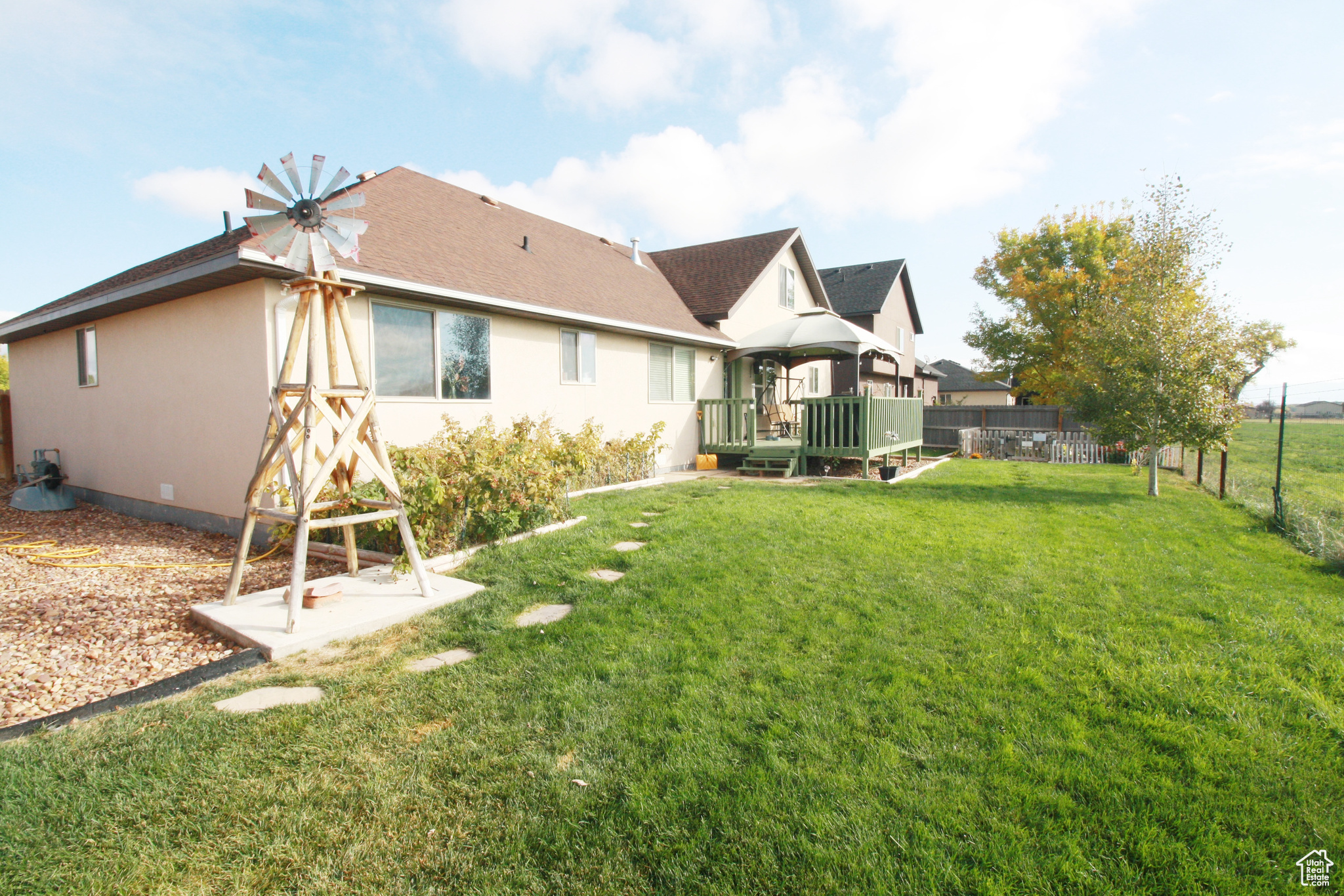 Rear view of property with a deck and a lawn