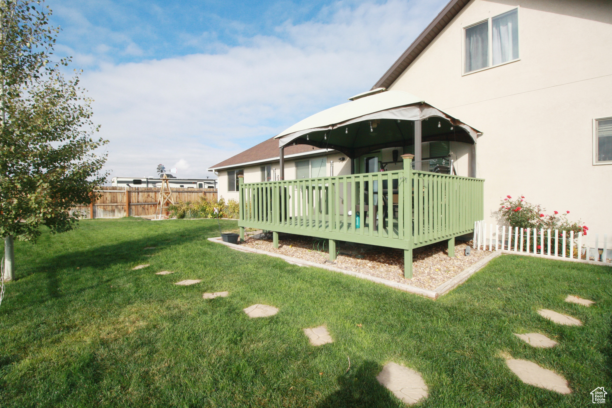 View of yard featuring a gazebo and a wooden deck