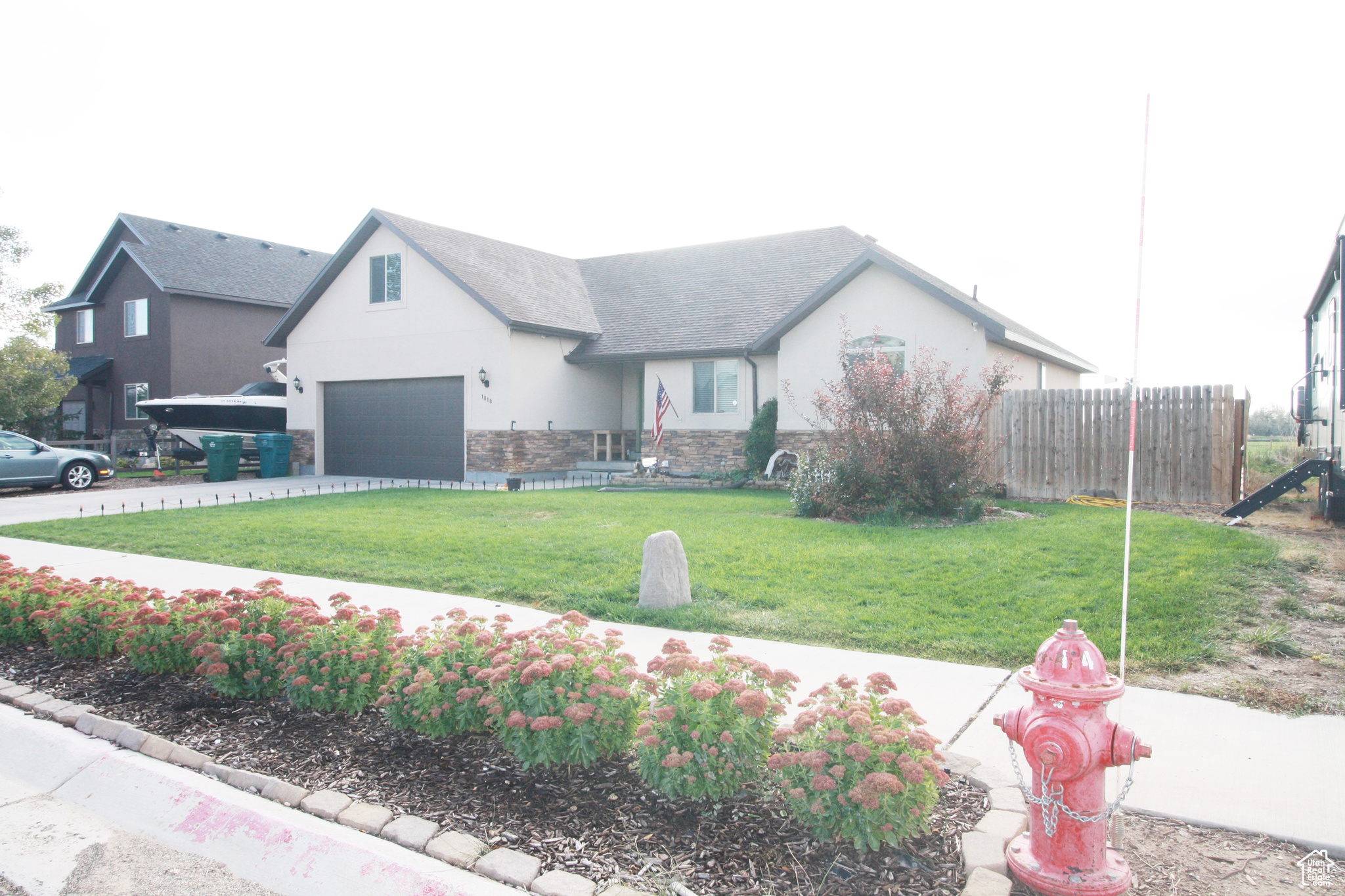 View of front of house with a front lawn and a garage