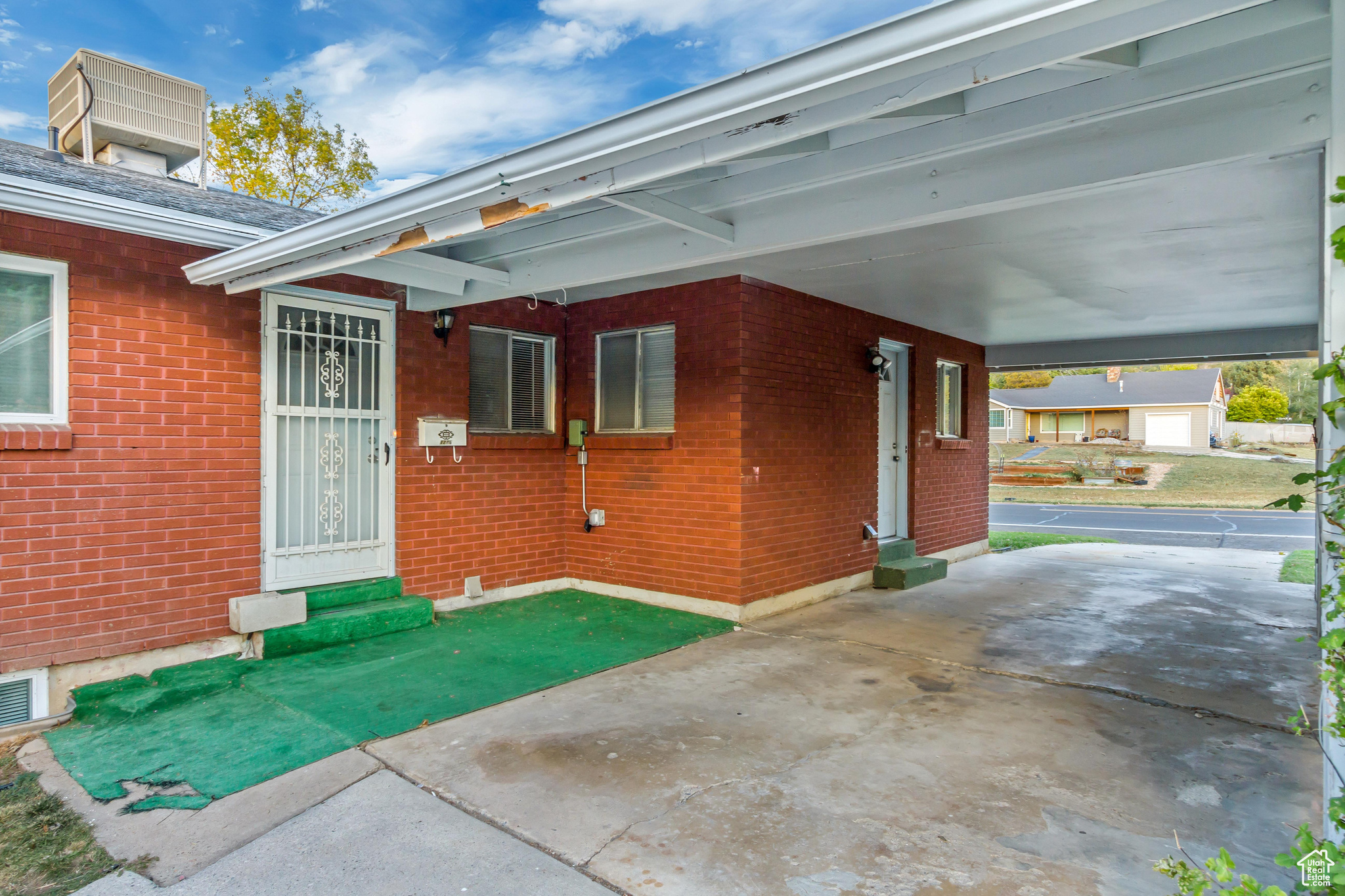 View of patio with a garage and a carport