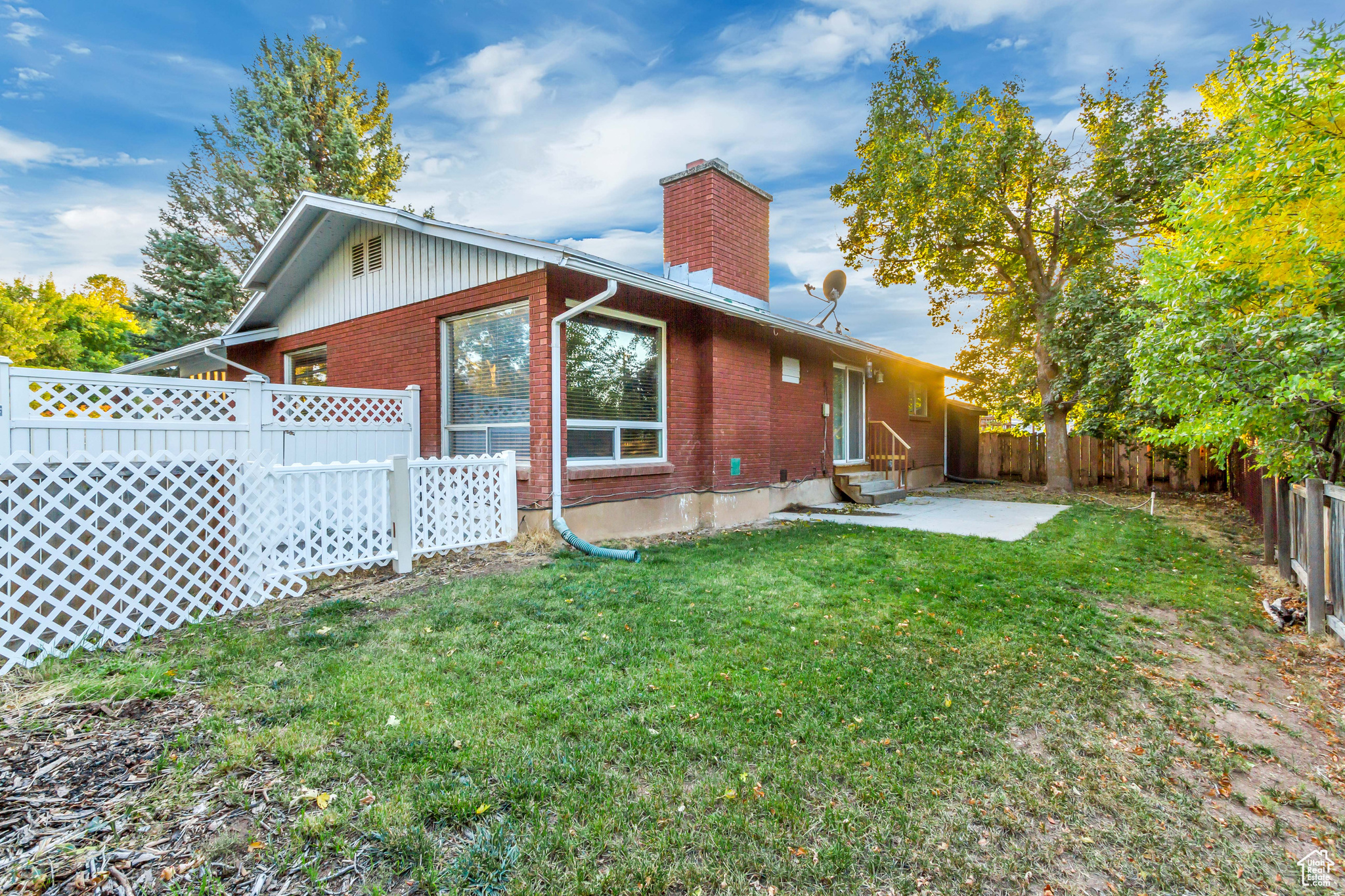 Rear view of house featuring a yard and a patio area