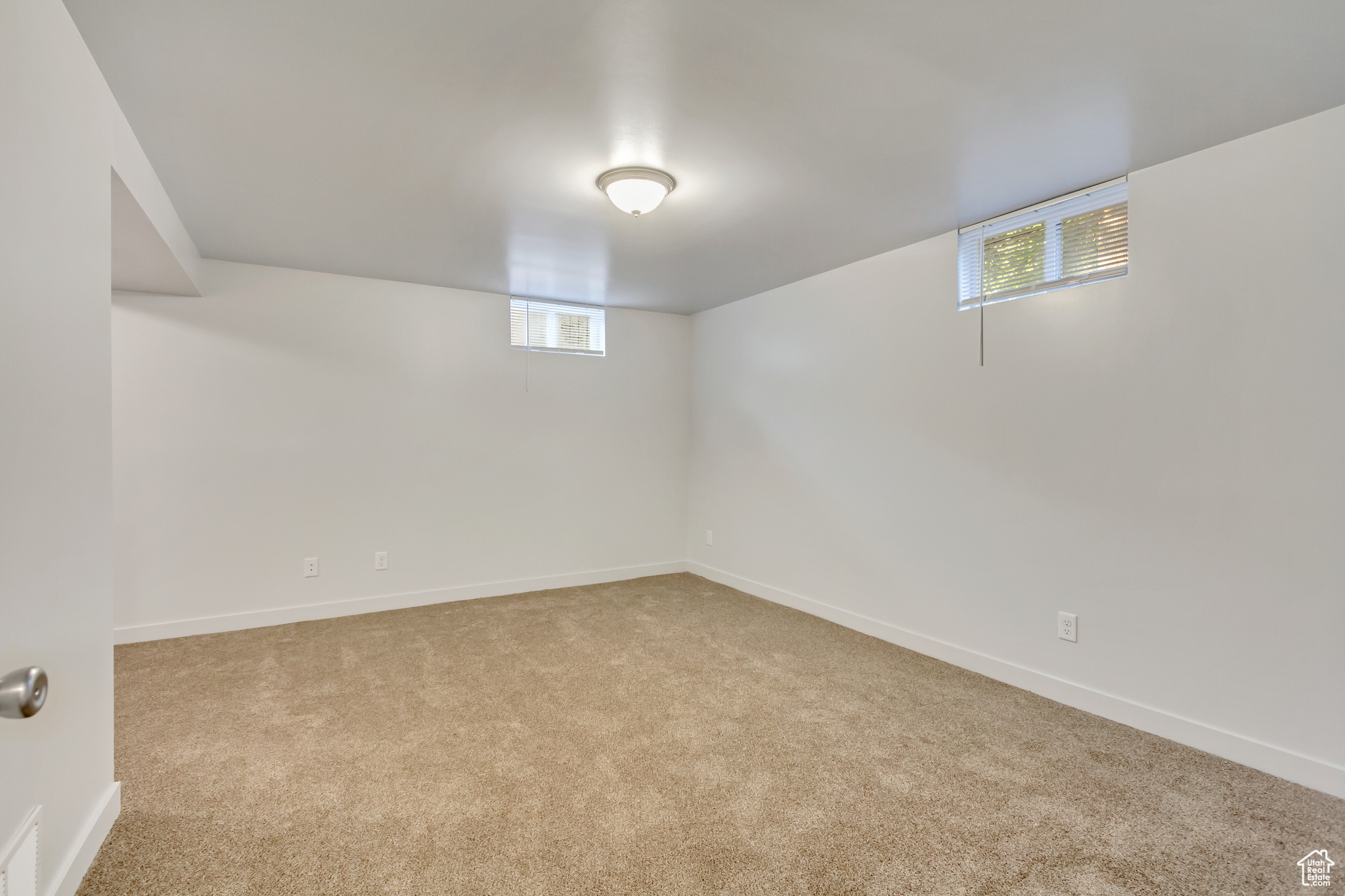 Basement with light colored carpet