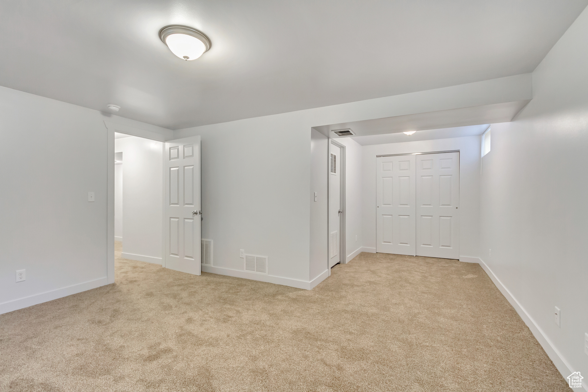 Unfurnished room with light carpet