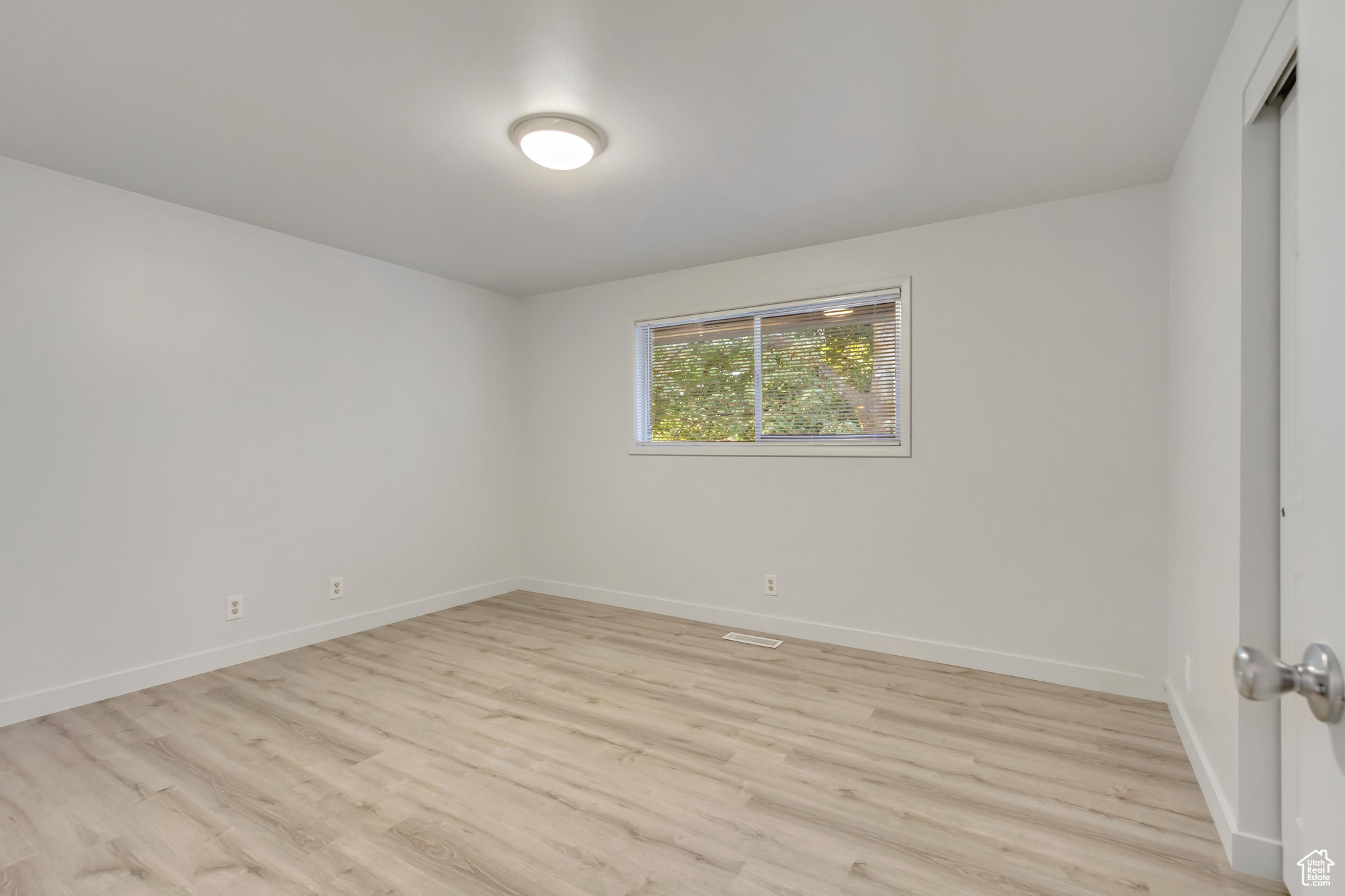 Empty room featuring light hardwood / wood-style flooring