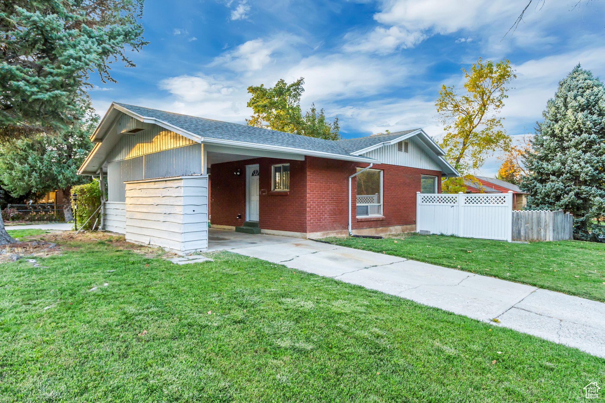 Ranch-style home with a front yard and a carport