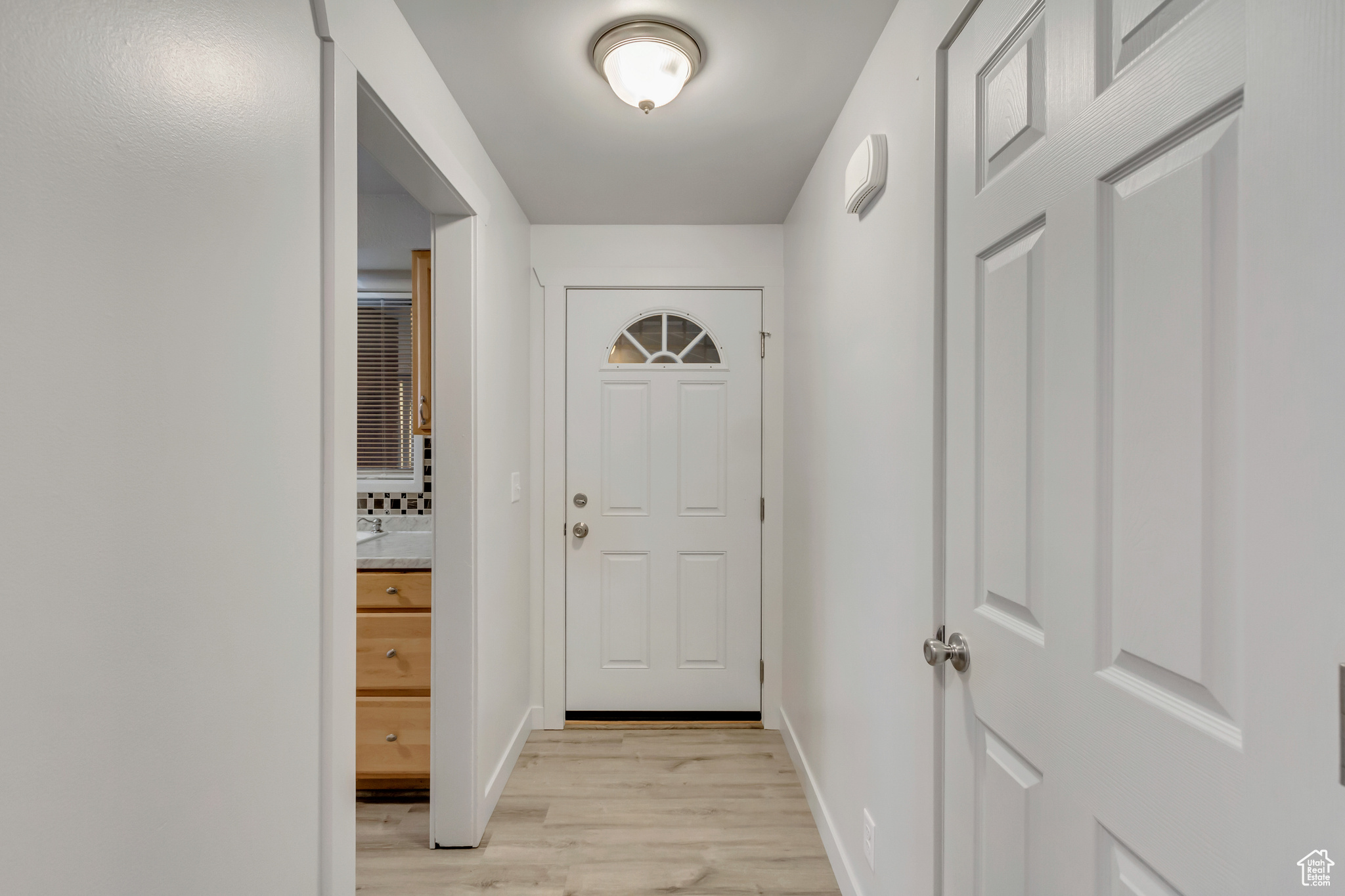 Doorway to outside with light wood-type flooring