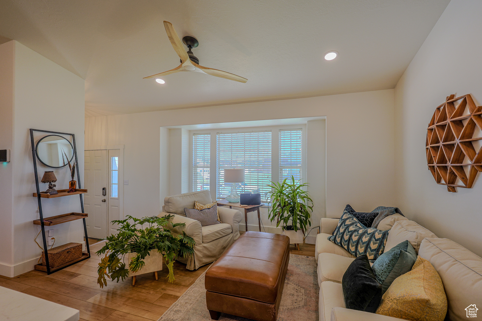 Living room with light hardwood / wood-style flooring and ceiling fan