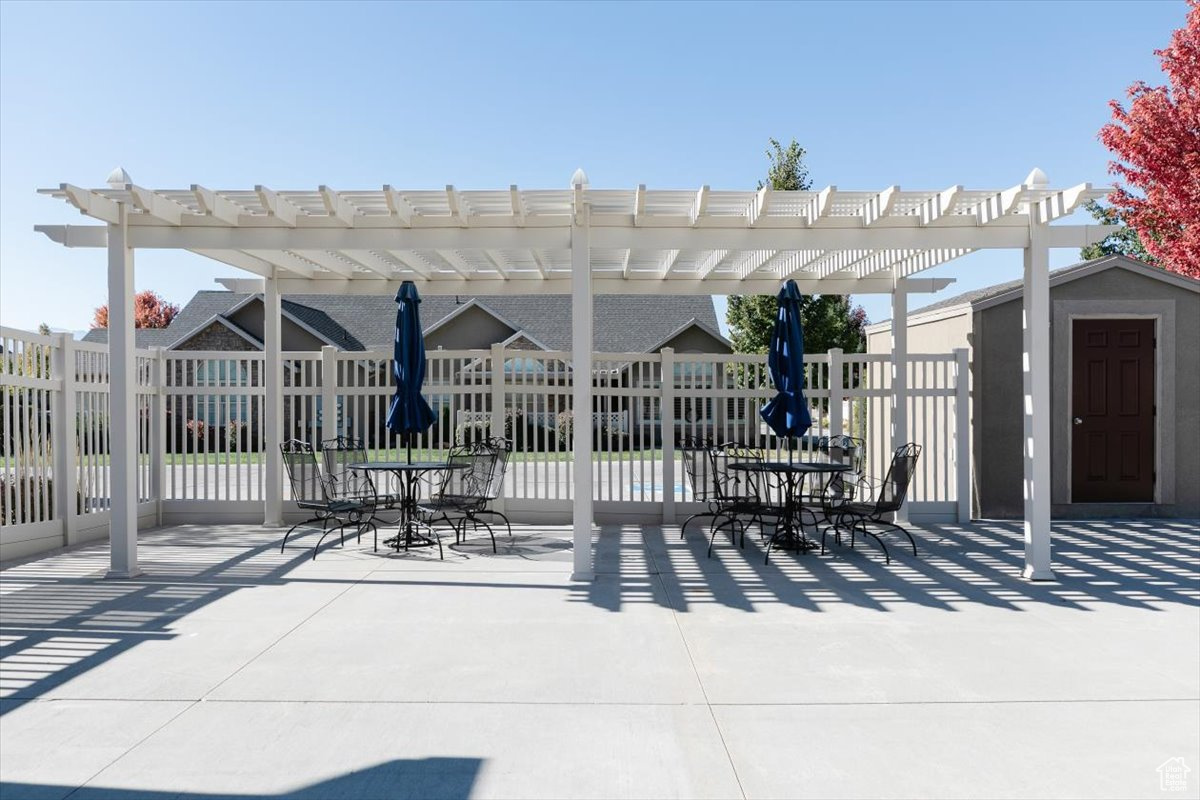 View of patio featuring a storage unit and a pergola