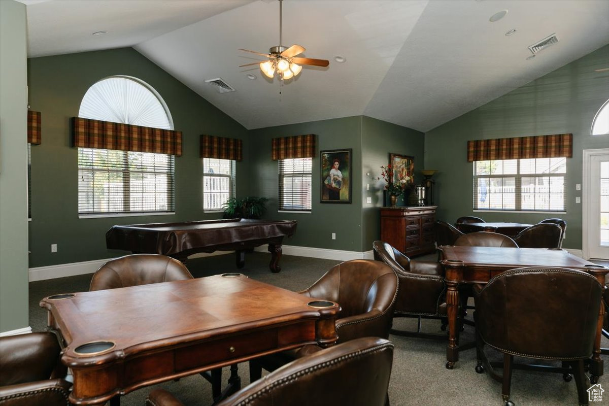 Dining area with a healthy amount of sunlight, vaulted ceiling, pool table, and light colored carpet