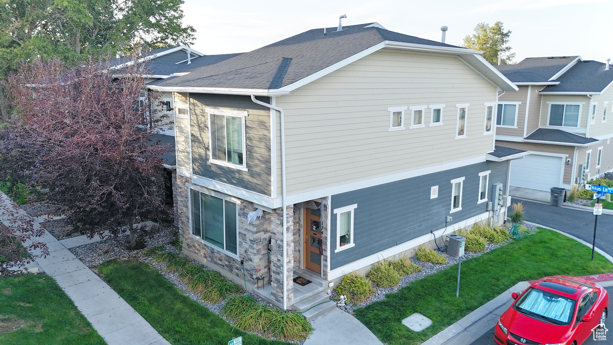 View of side of home featuring a yard, a garage, and cooling unit