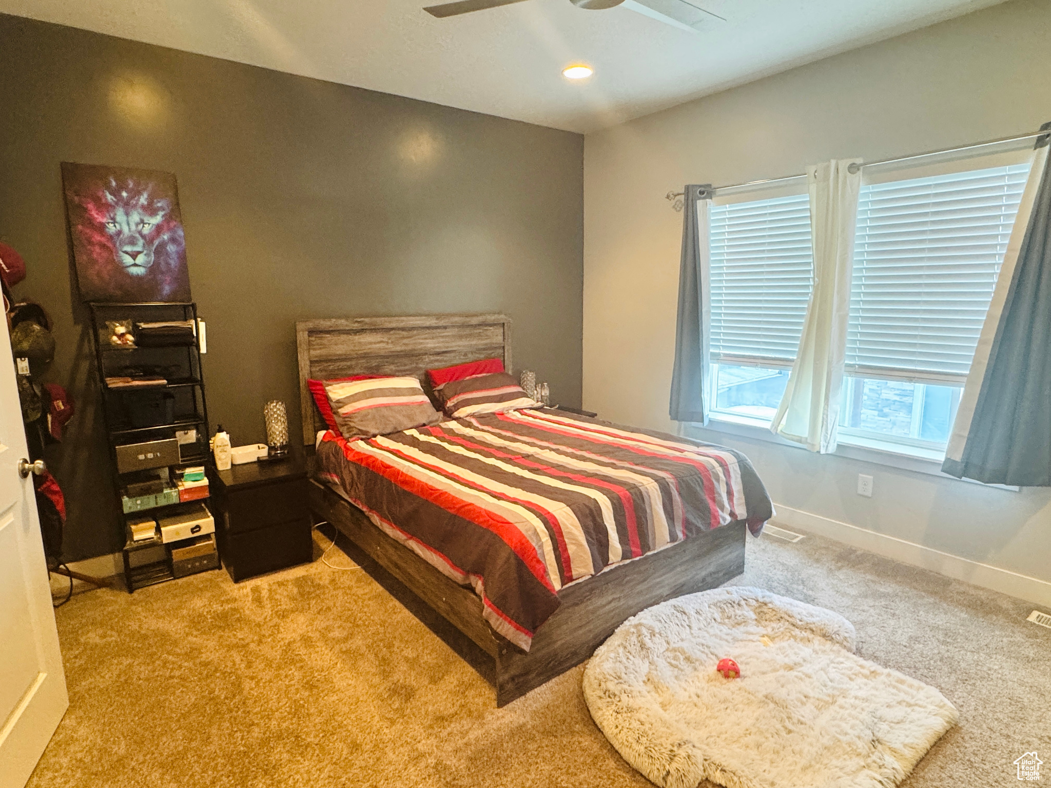 Bedroom featuring light colored carpet and ceiling fan