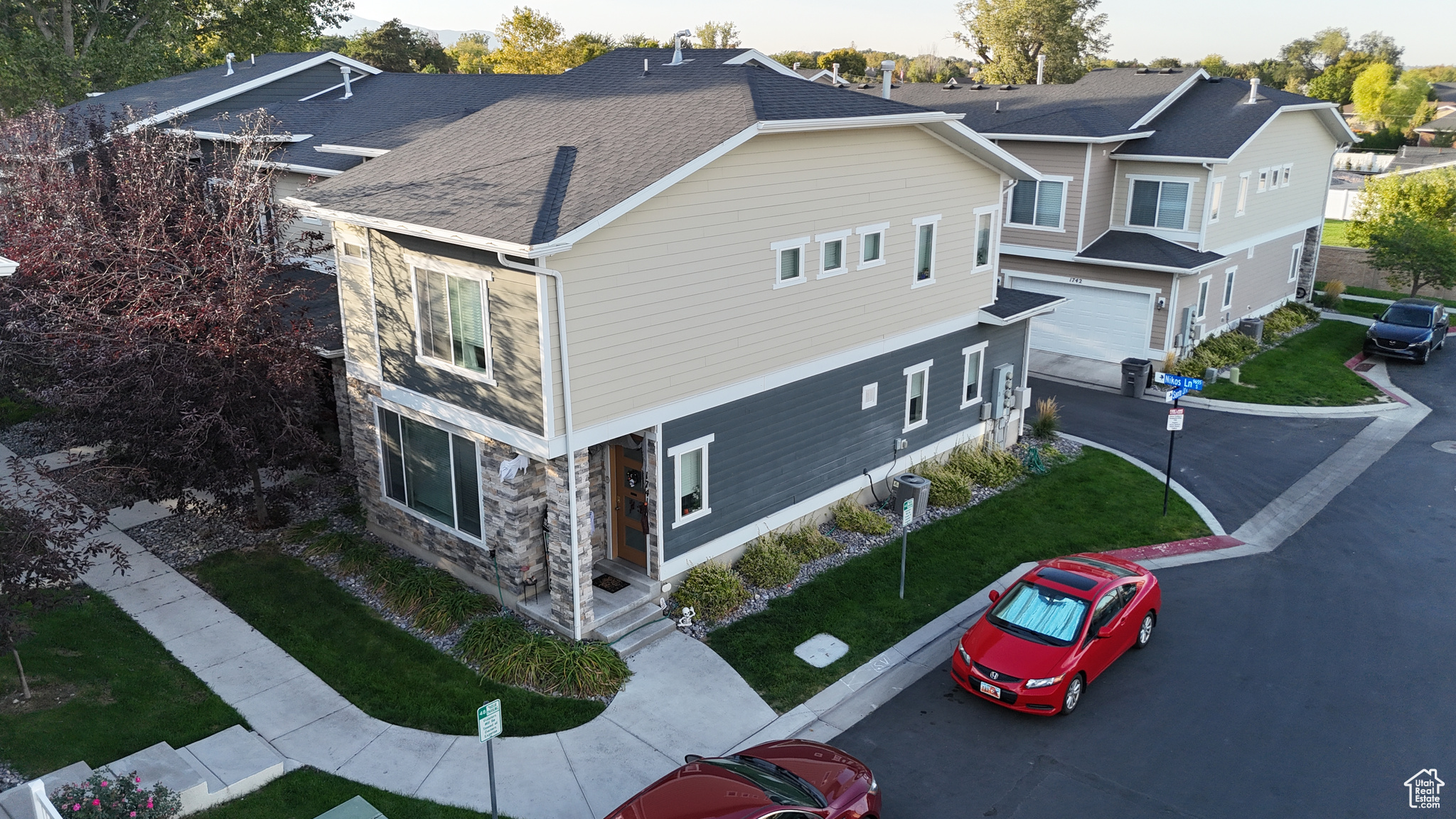 View of side of home with a lawn and a garage