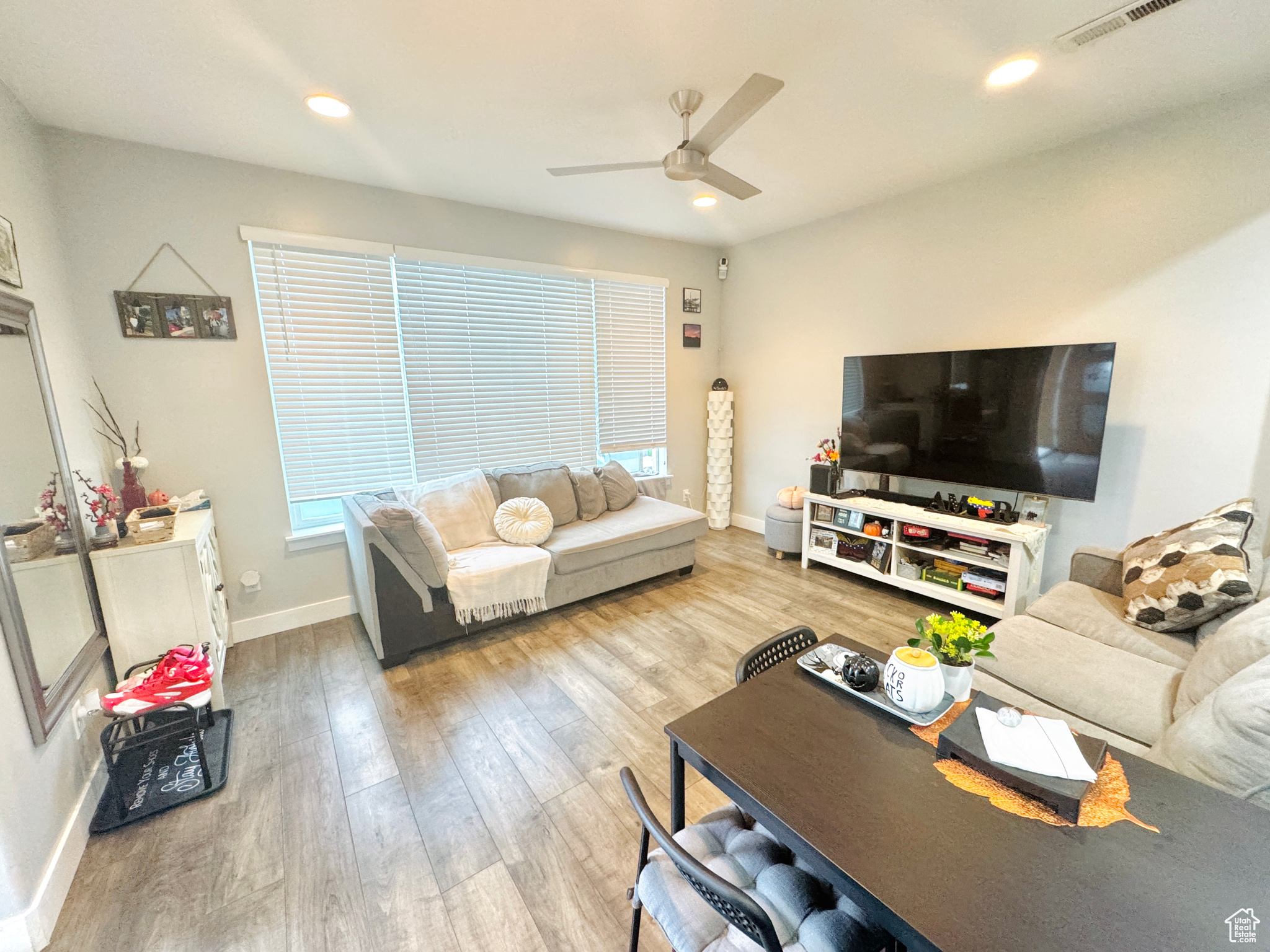 Living room with wood-type flooring and ceiling fan