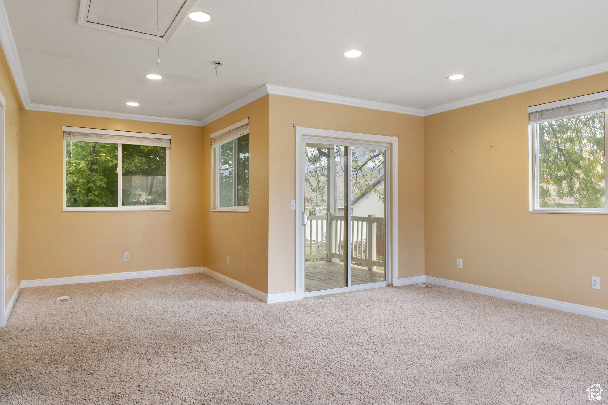 Family room with light carpet and crown molding