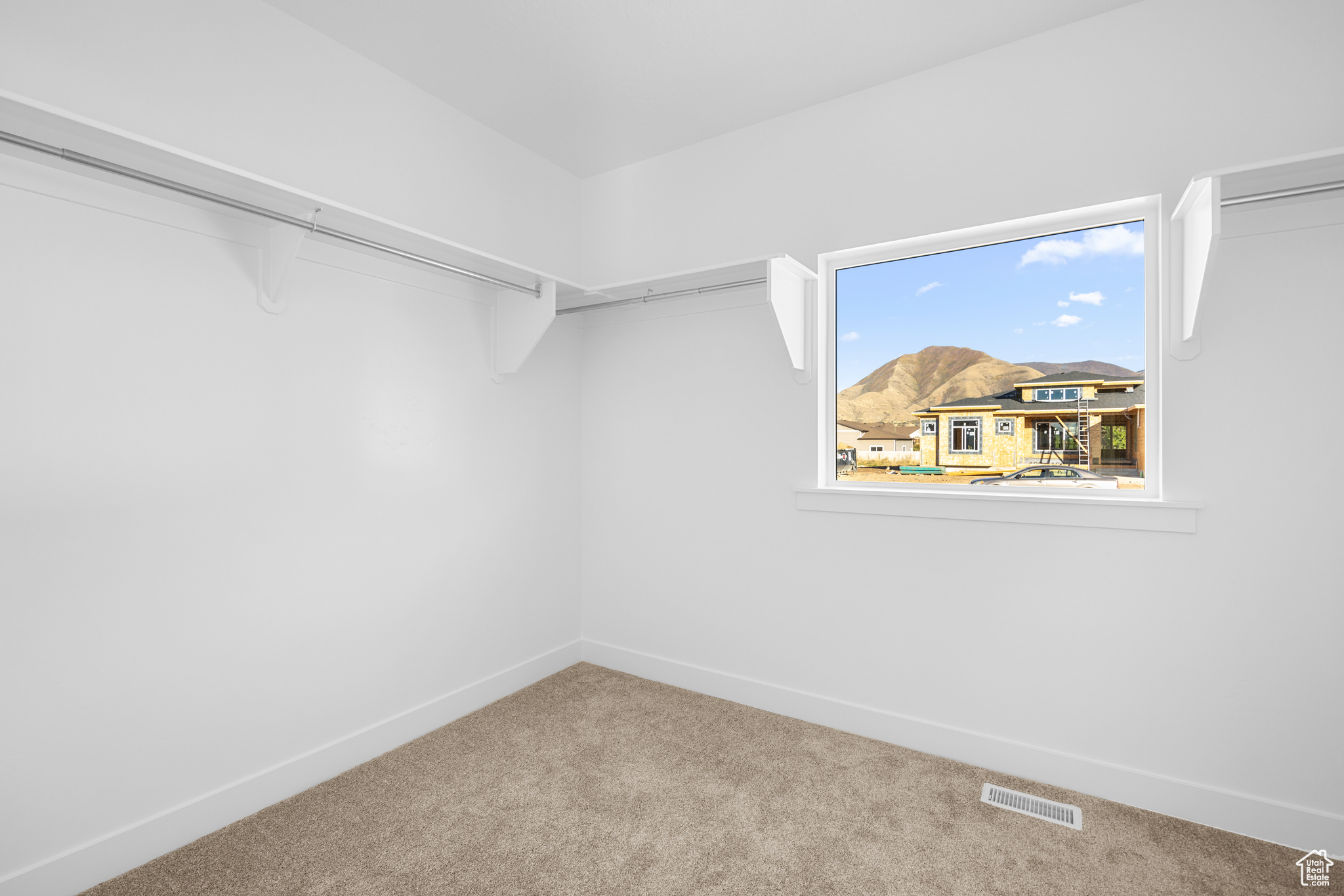 Spacious closet with carpet and visible vents