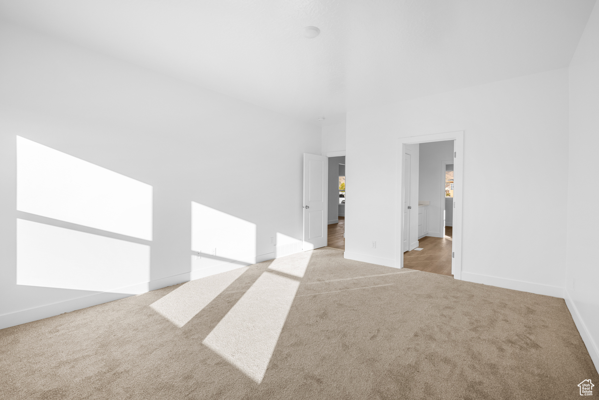 Interior space featuring light carpet and baseboards