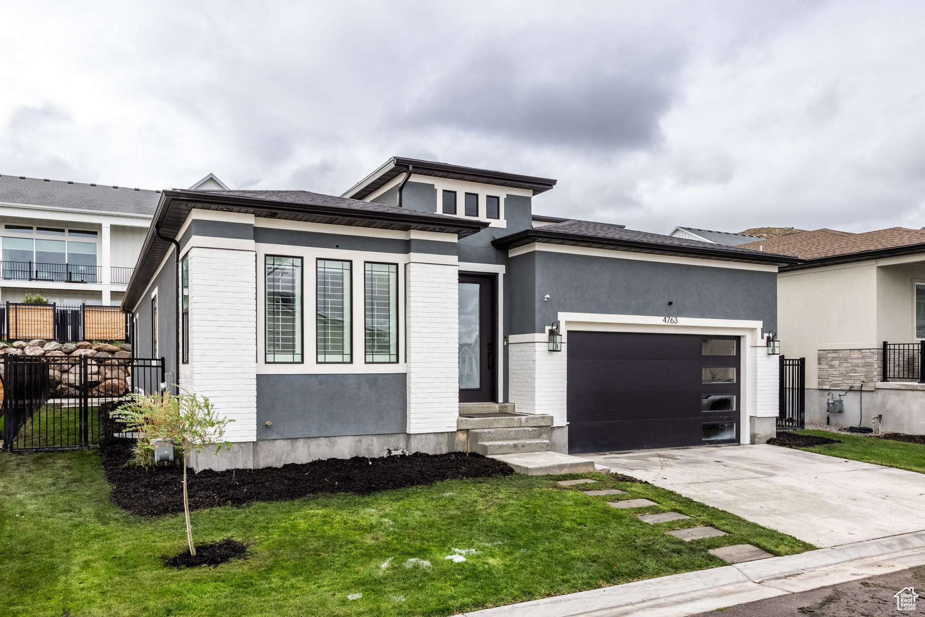 View of front of home featuring a front yard and a garage