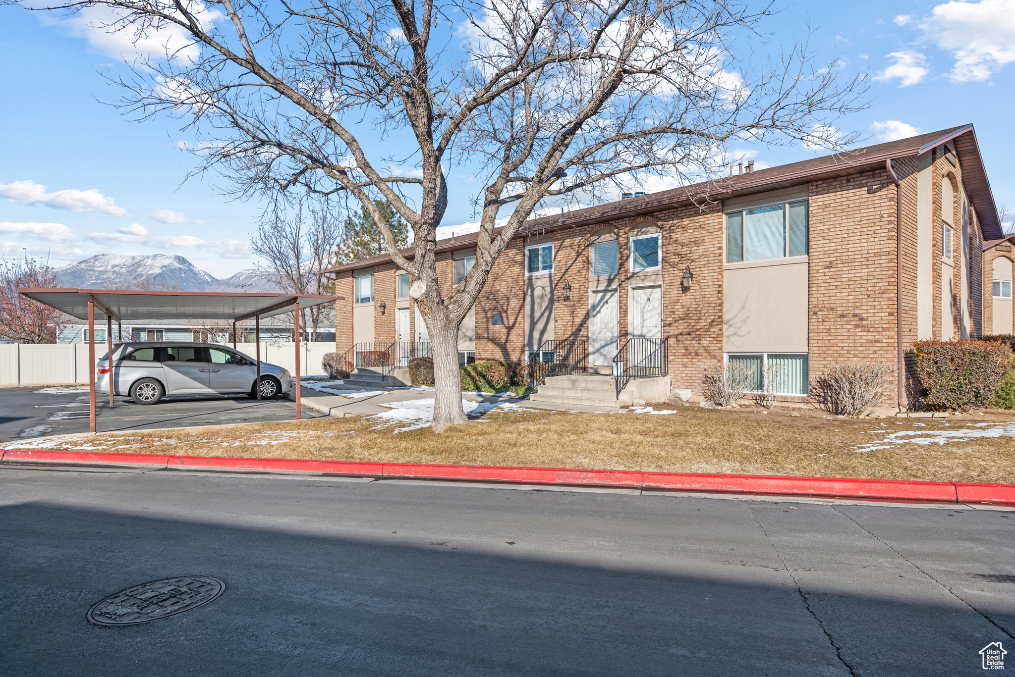 View of front facade featuring a carport and a mountain view