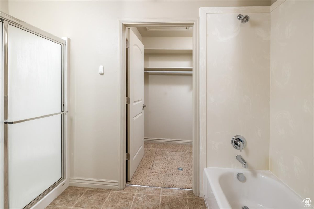 Bathroom featuring tile patterned floors and plus walk in shower