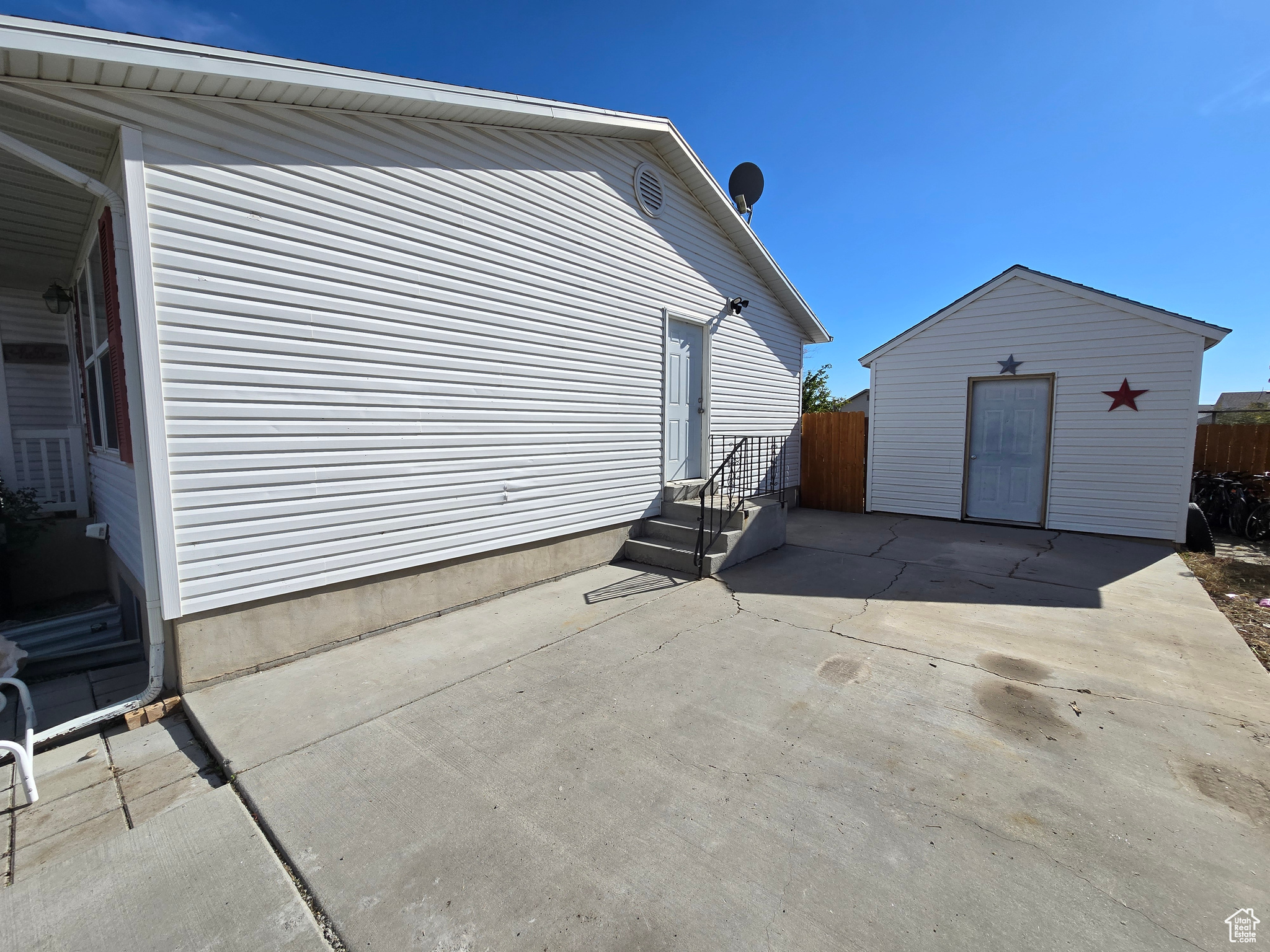 Exterior space with a storage shed and a patio