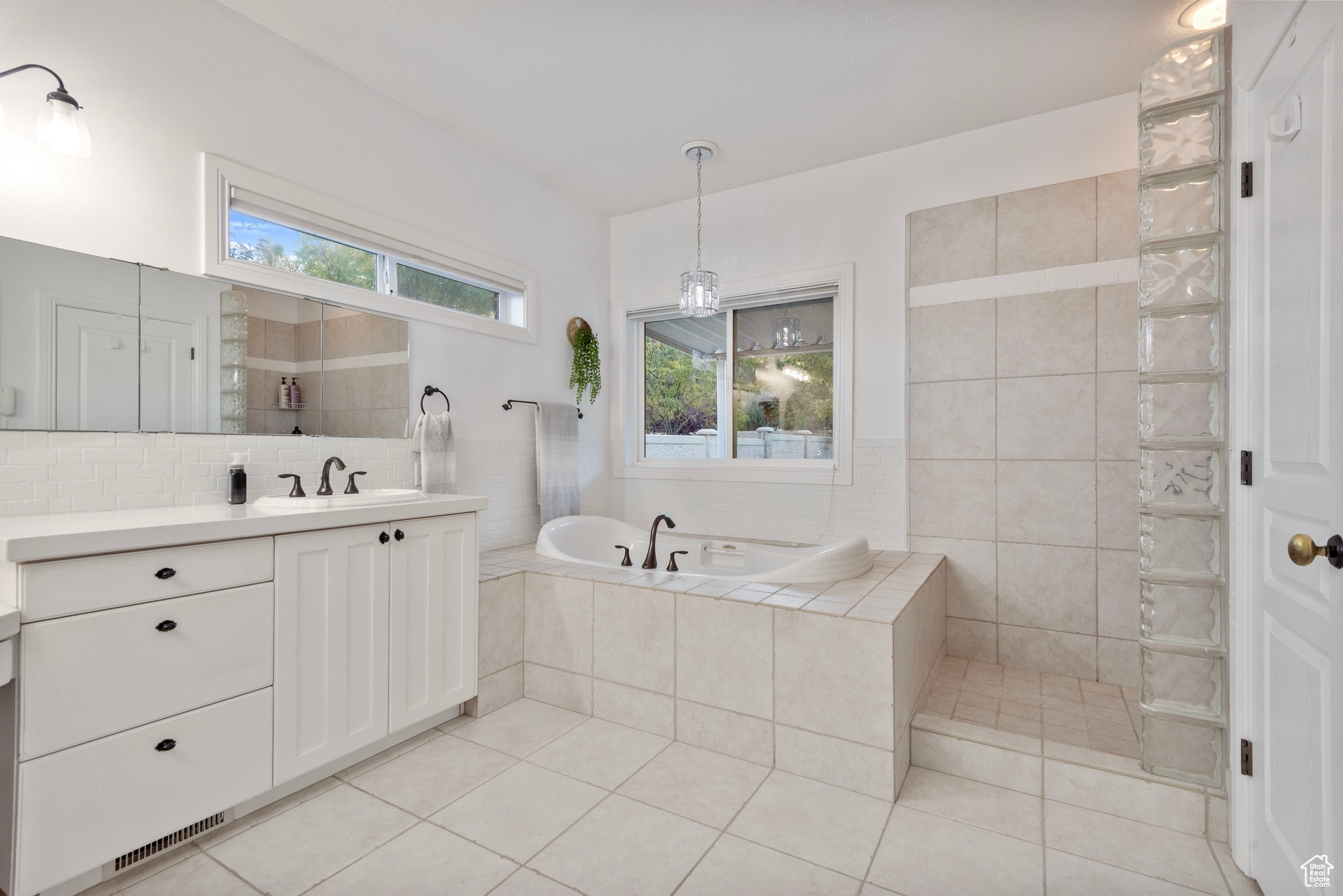 Bathroom with vanity, plus walk in shower, and tile patterned flooring