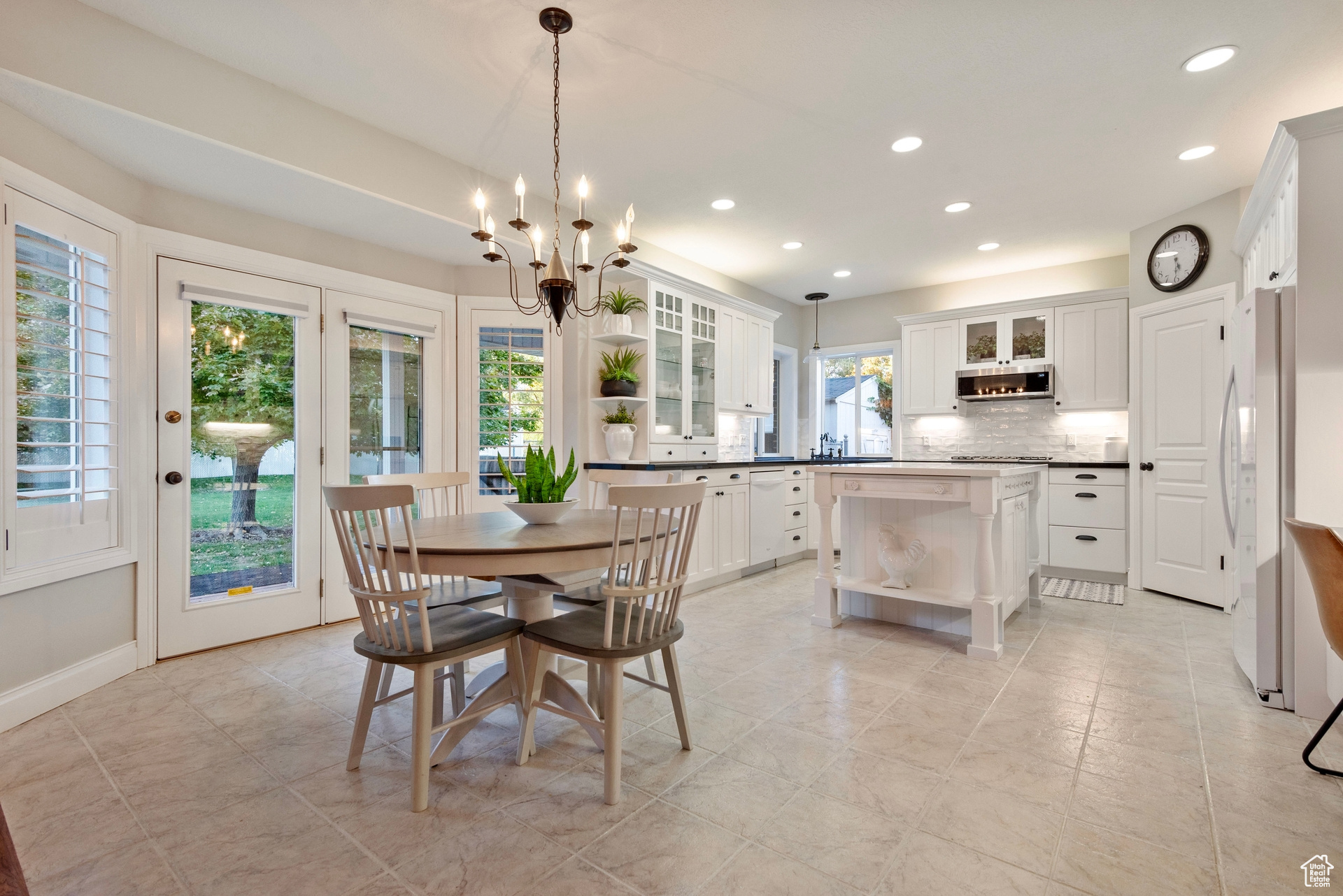 Dining room with an inviting chandelier and a wealth of natural light