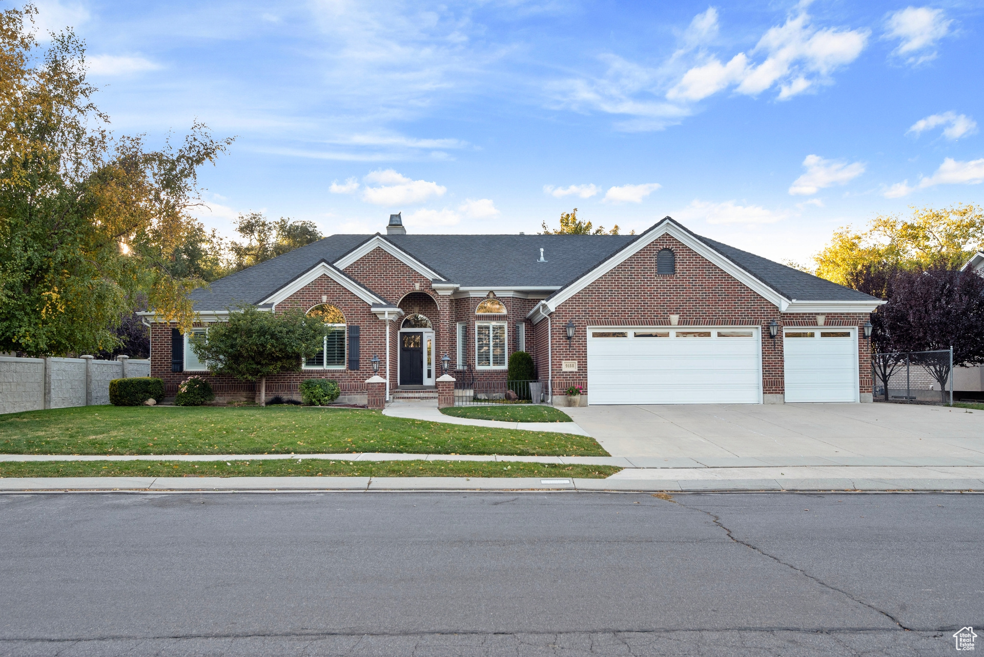 Ranch-style house featuring a front lawn and a garage