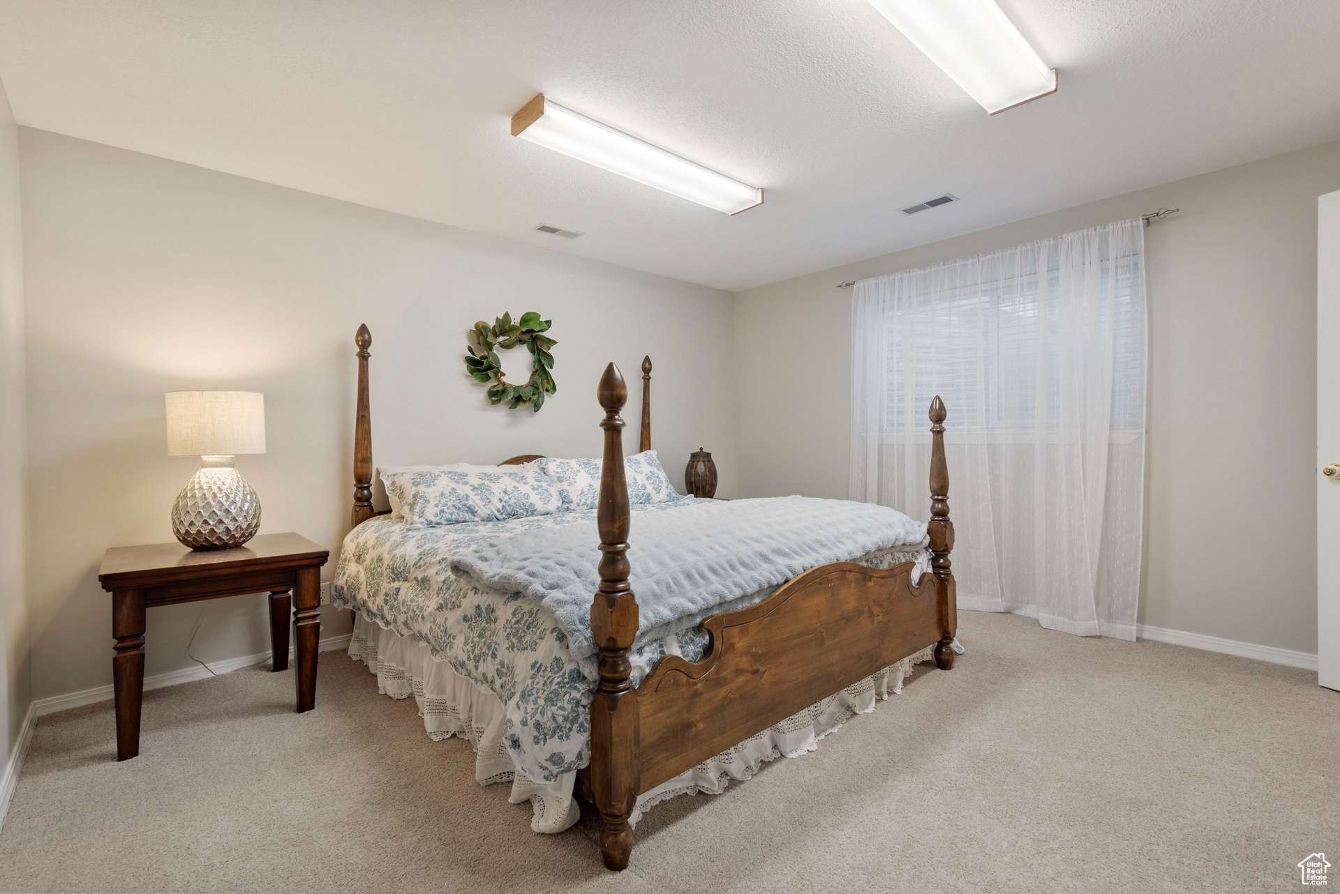 Bedroom with light carpet