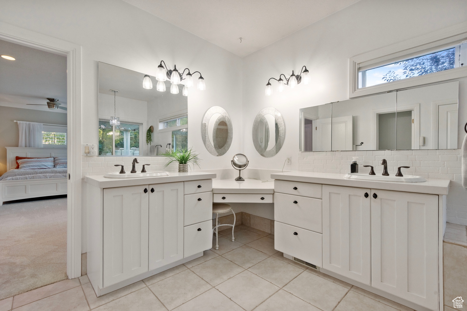 Bathroom featuring vanity, decorative backsplash, tile patterned floors, and ceiling fan