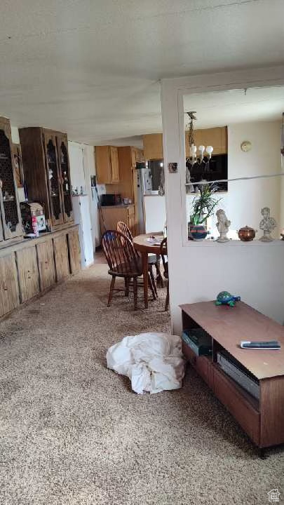 Dining area with a chandelier and carpet