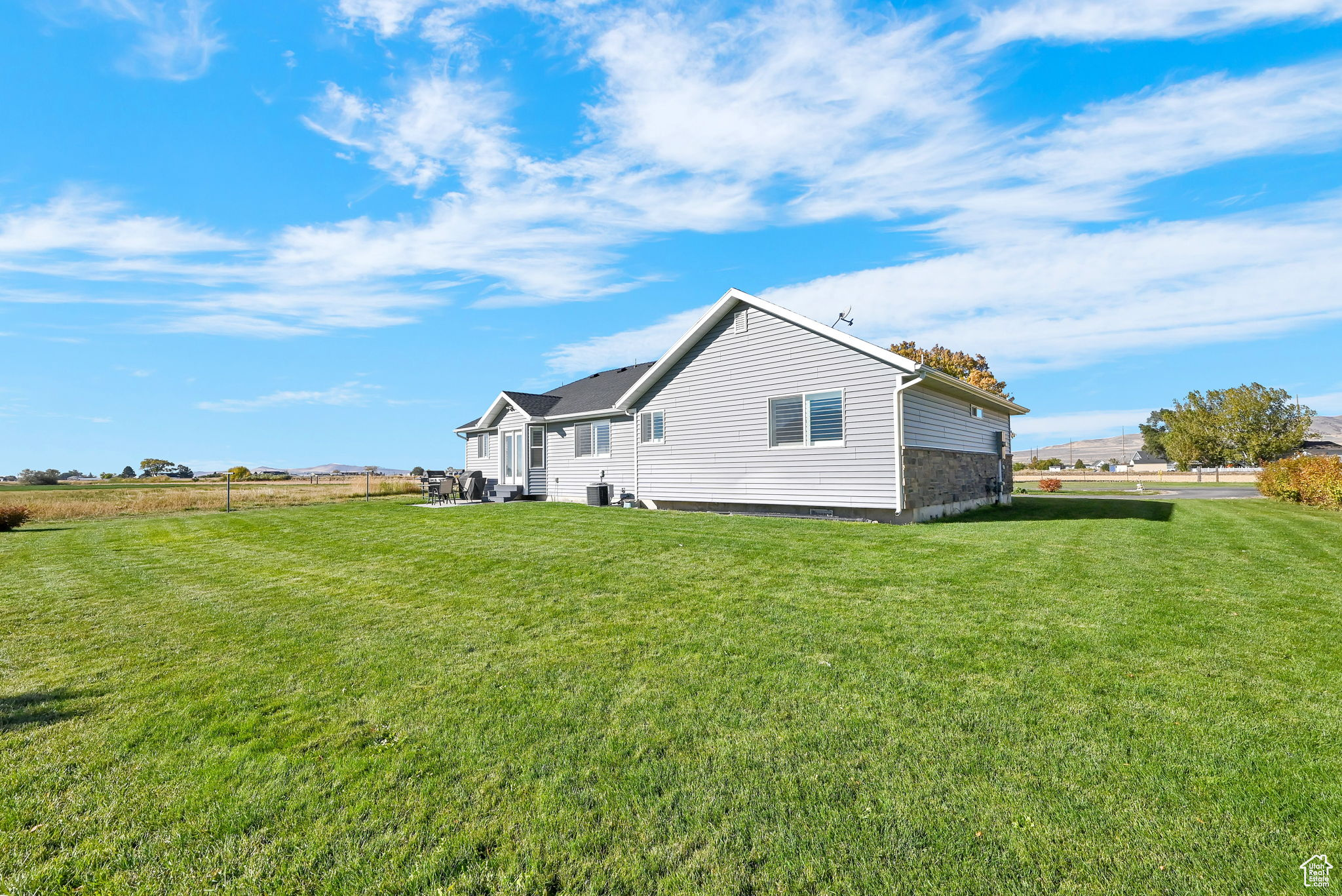 View of side of home featuring a lawn